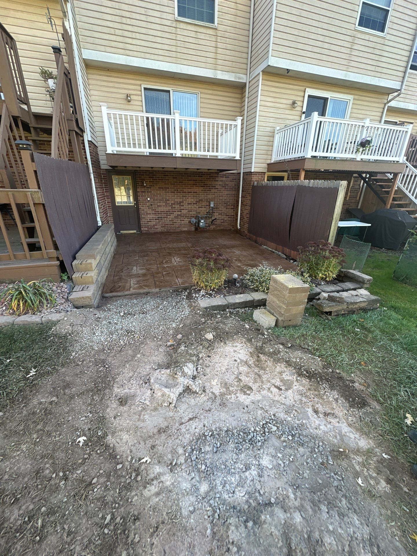 Stamped concrete and redeck  by Cousins Roofing Siding & Decks