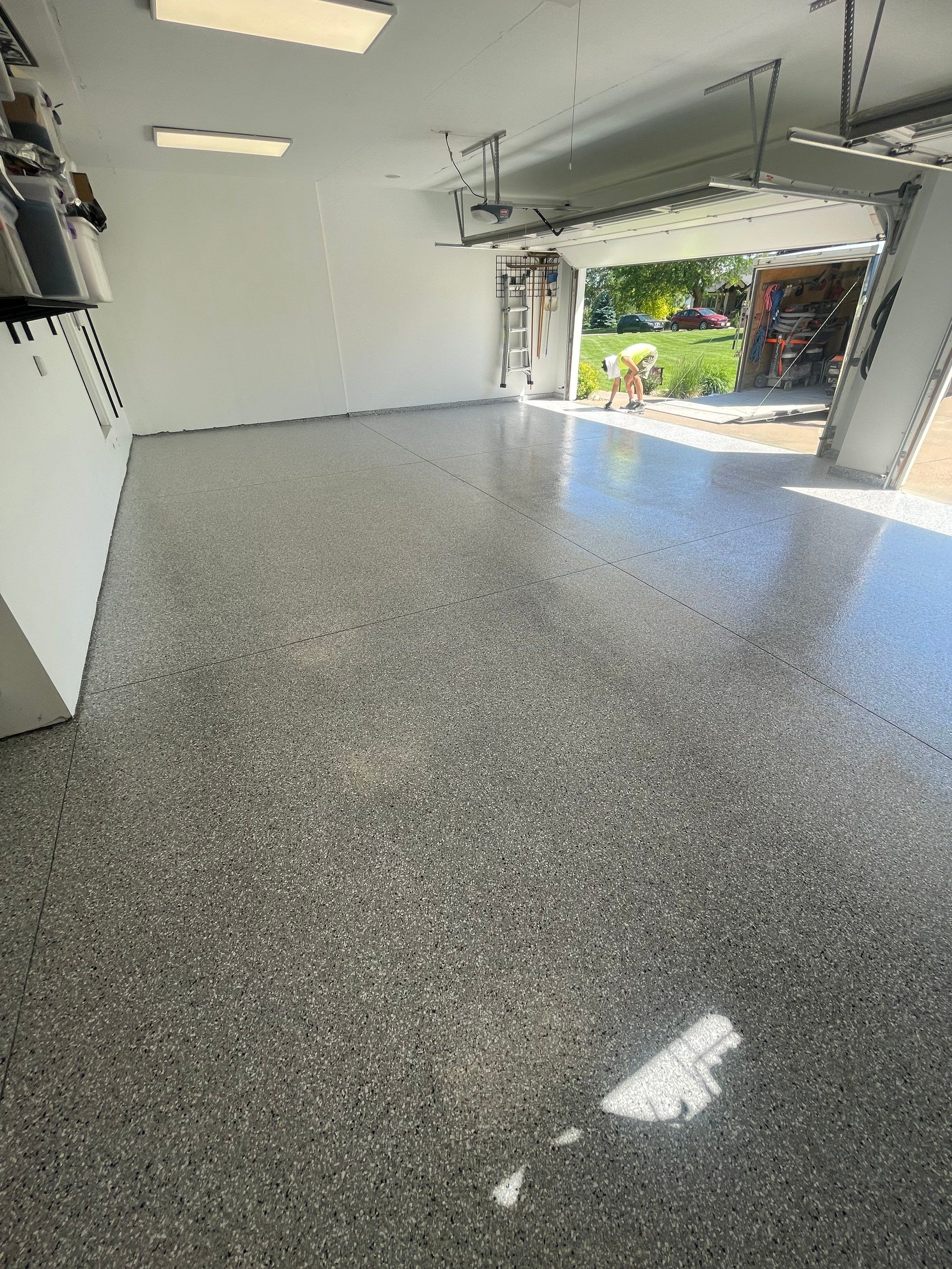 Feather Grey Garage Floor Coating Installation in Sioux Falls by Select Painting, Coatings & Garage Cabinets