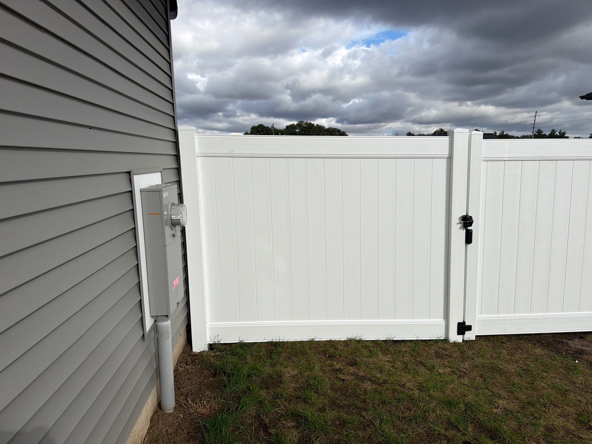 Residential White Vinyl Privacy Fence Installation in Janesville by Perfect Picket Fence and Stain