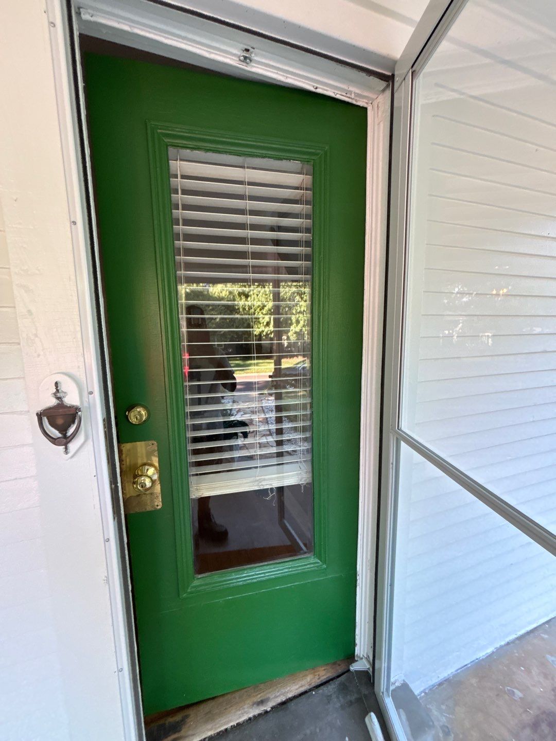 This 100-year-old home shines with a fresh coat of Spare White, bold Arugula accents on the front door and shutters, and a warm Fired Brick deck for timeless curb appeal. by Cougar Painting
