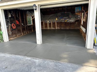 Concrete garage floor replacement with a broom finished apron 