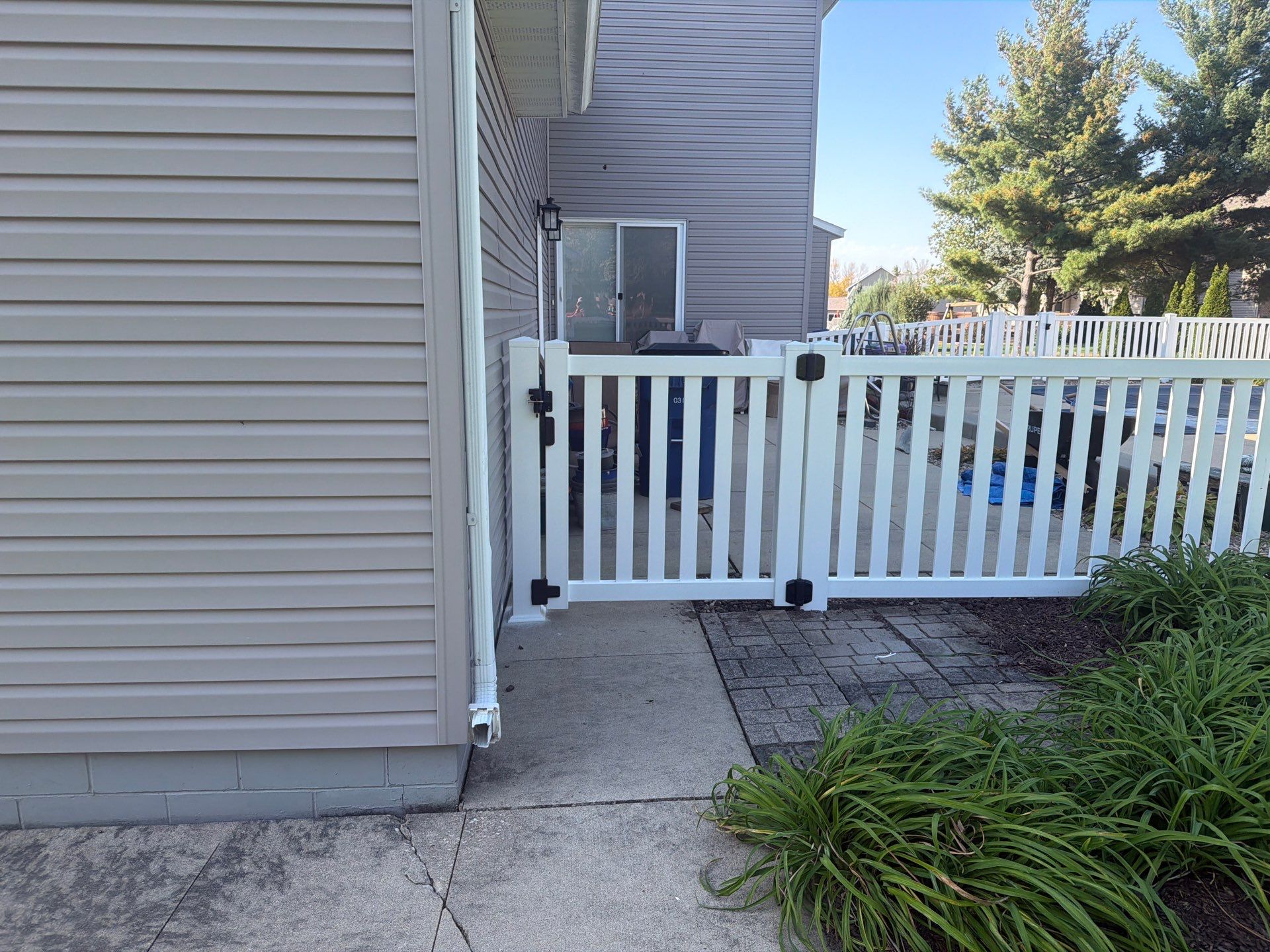 White Vinyl Picket Pool Fence Installation in Waterloo, Iowa by Perfect Picket Fence and Stain