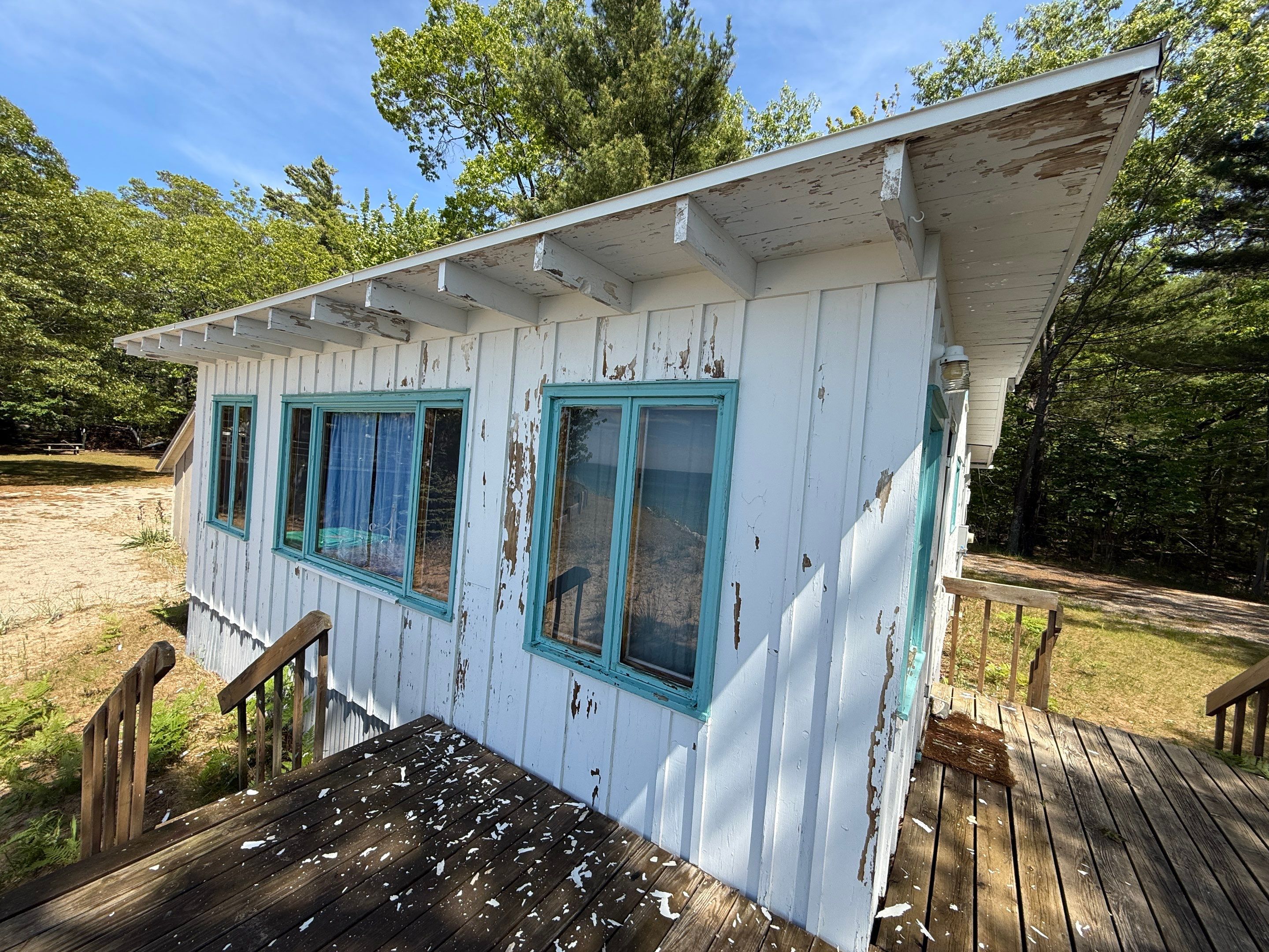Lakeside Cottage Exterior Painting and Teal Trim Restoration in Mears by Gordon Painting