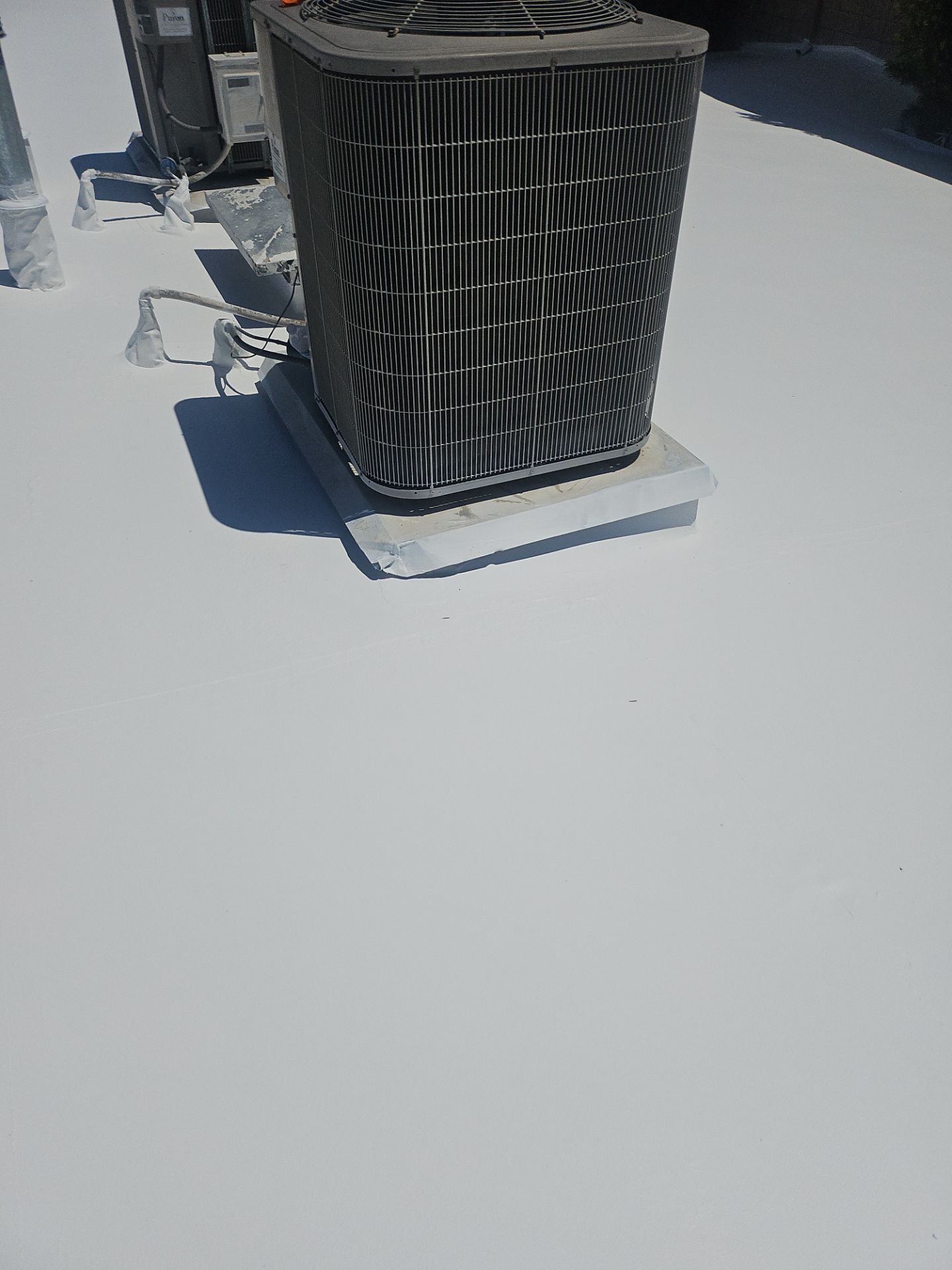 Single-ply restoration system using Benchmark/PUMA XL coatings over TPO single-ply roofing by Straight Edge Roofing Inc