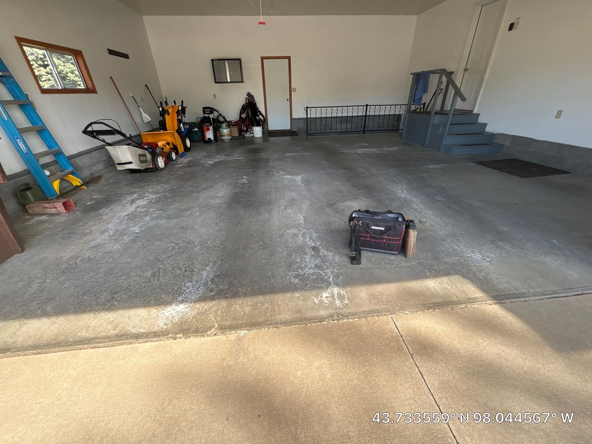 Feather Grey Garage Floor Coating and Concrete Restoration in Mitchell by Select Painting, Coatings & Garage Cabinets