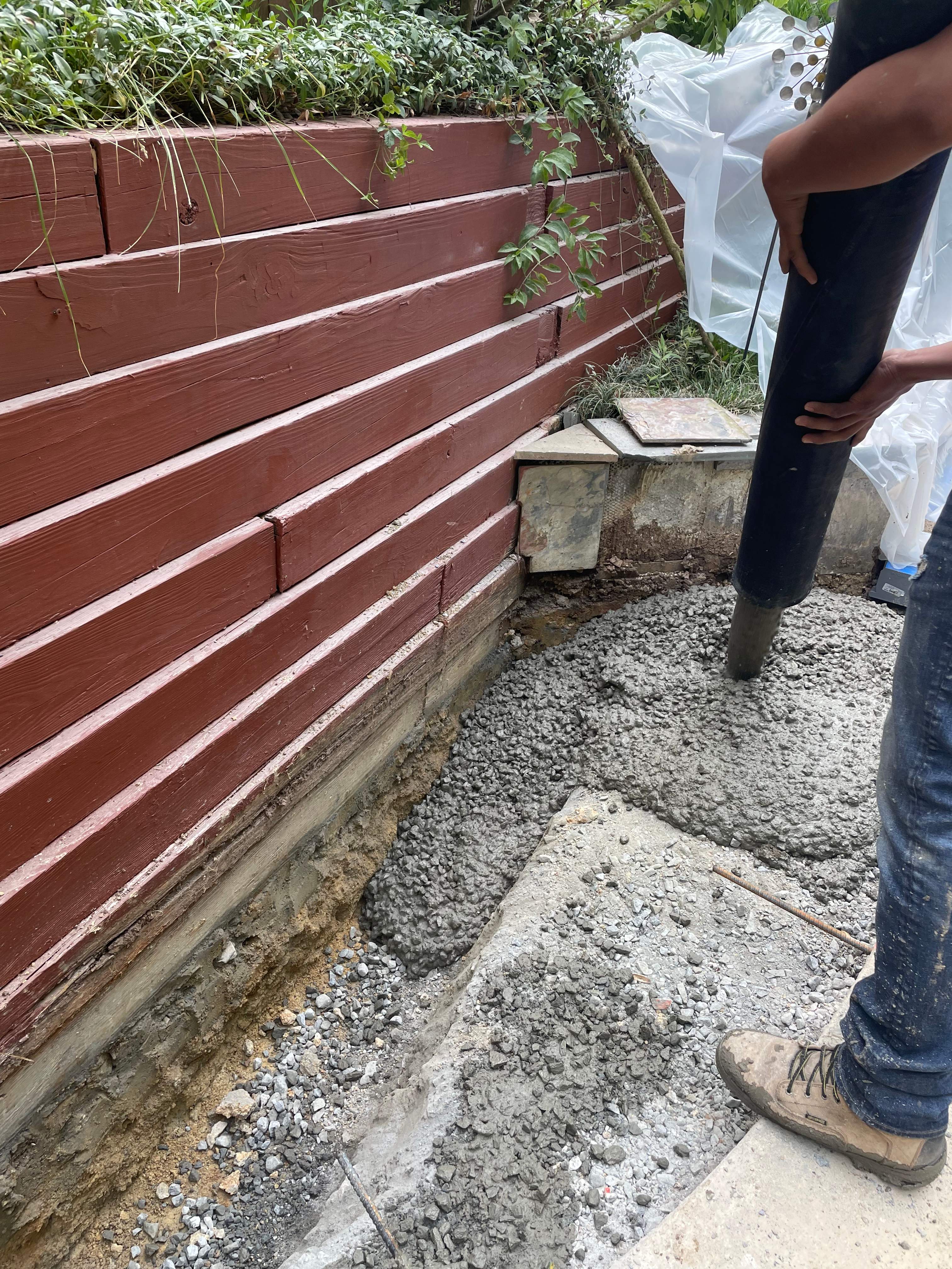 Pool Surround remodel with retaining walls, new waterfall and water slide by Fairfax Contractors, LLC