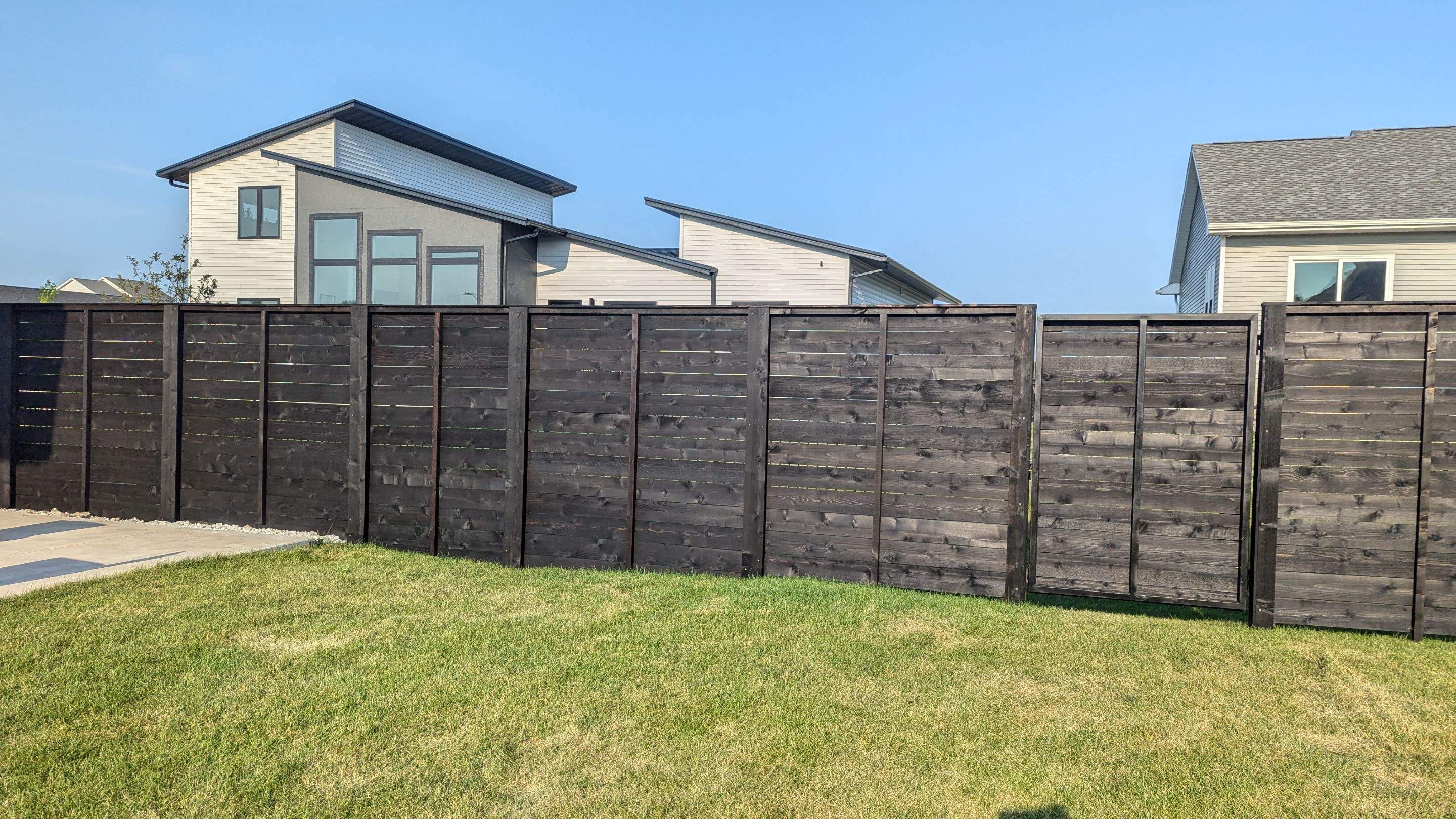 Modern Black Stained Horizontal Privacy Fence Installation in Cedar by Perfect Picket Fence and Stain