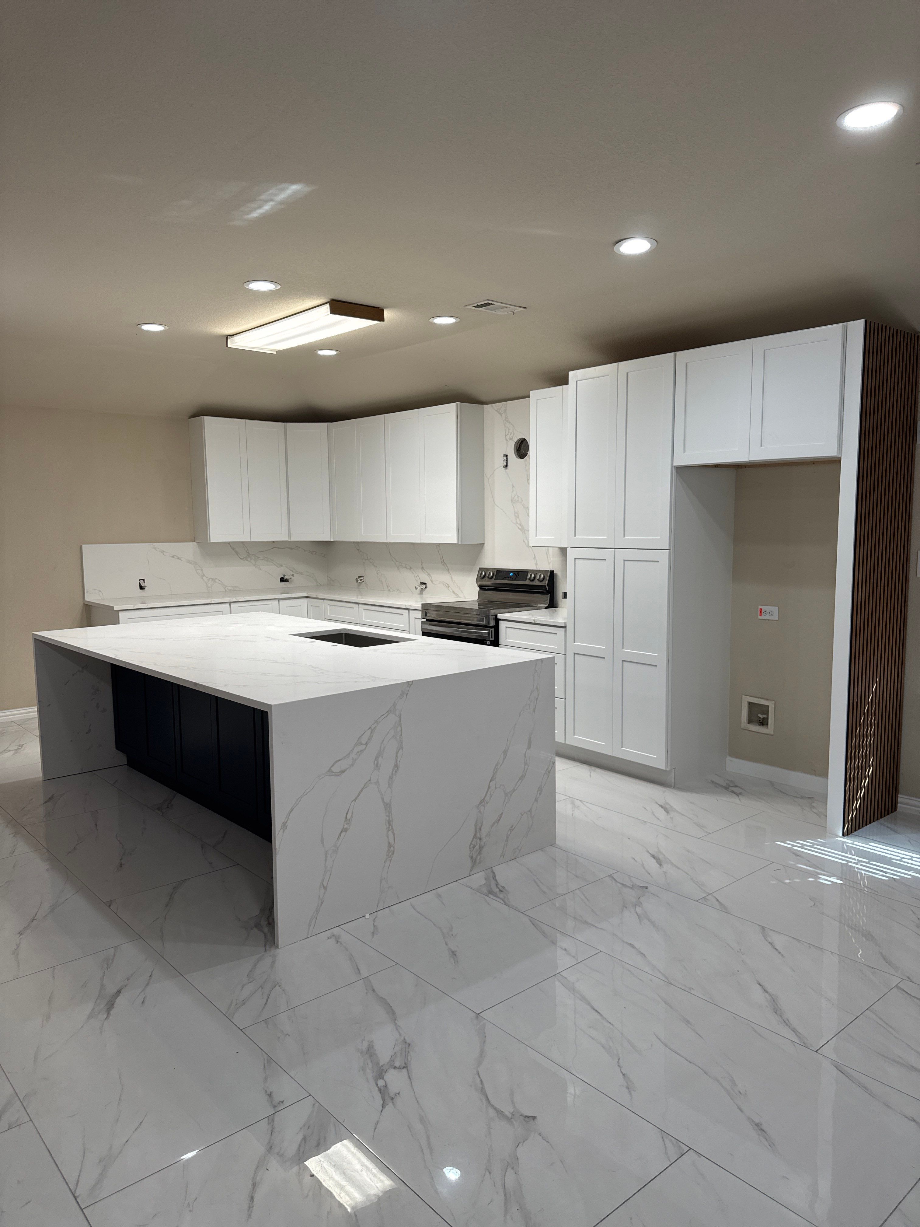 Luxury Focal Point: Full Kitchen Remodel with Double Waterfall Island by Tibi Soli LLC