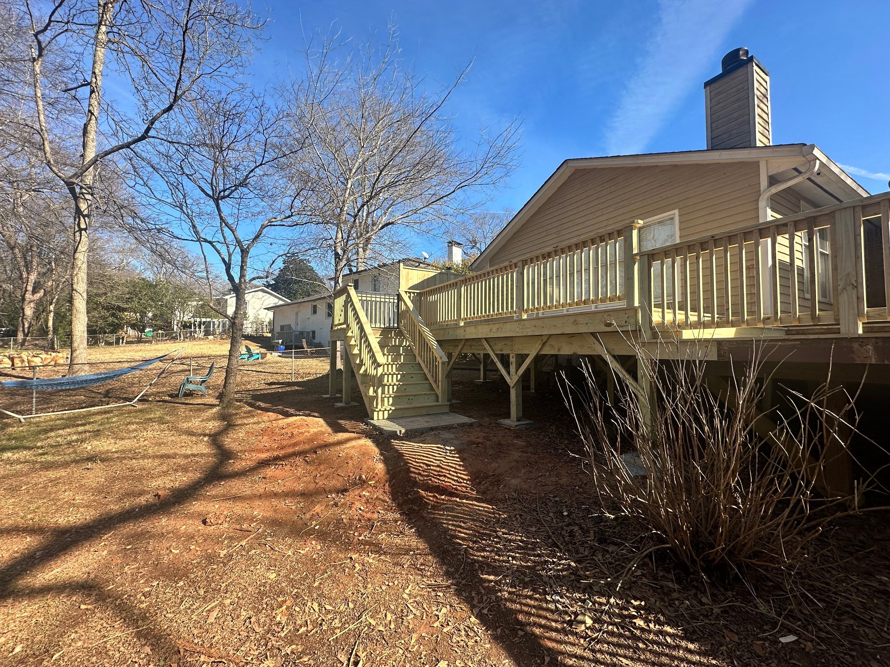 Elevated Pressure-Treated Wood Deck Extension in Marietta by Swift Home Renovations