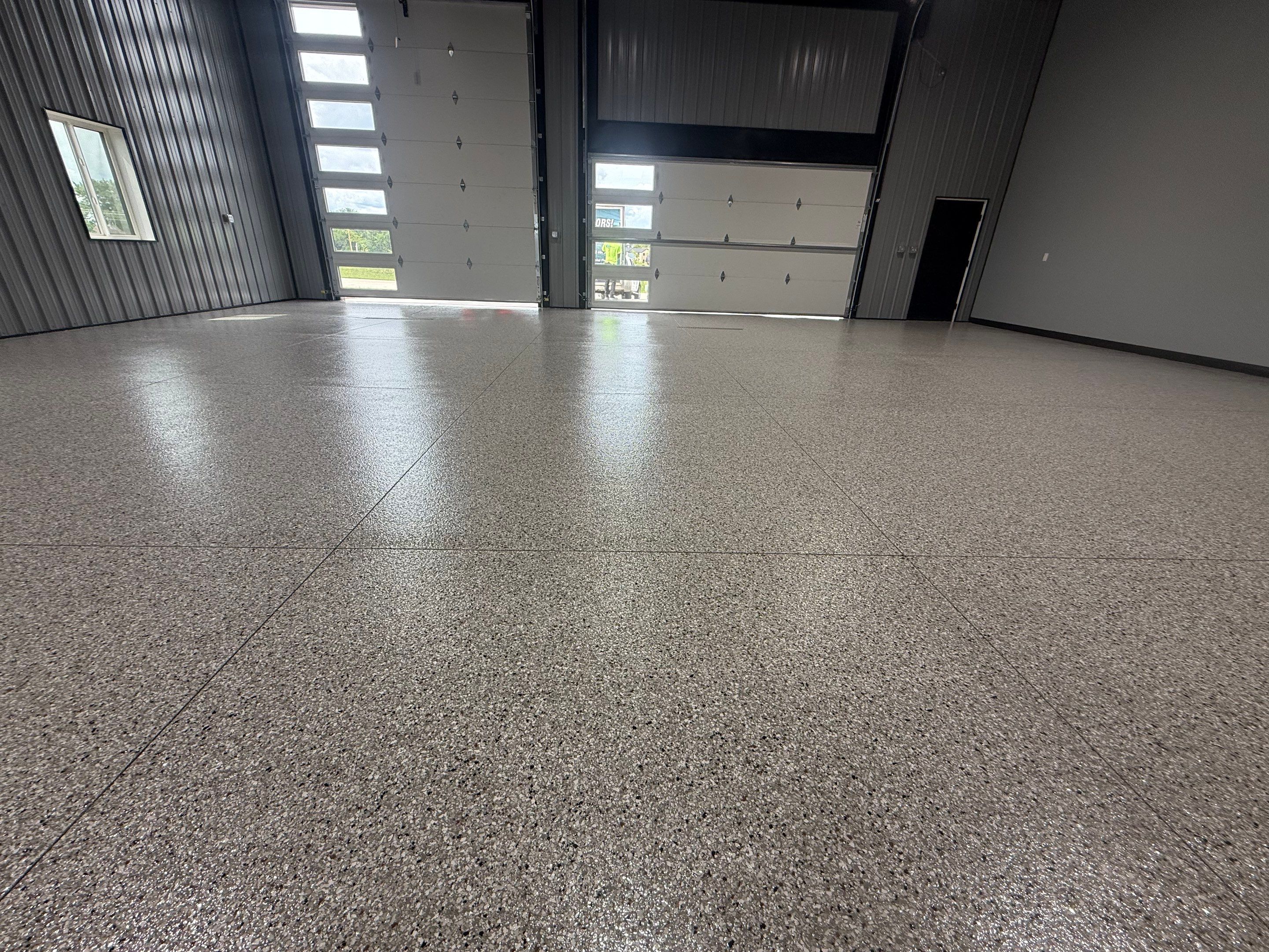 Polyaspartic Garage Floor Coating with Decorative Flake in Wentworth by Select Painting, Coatings & Garage Cabinets