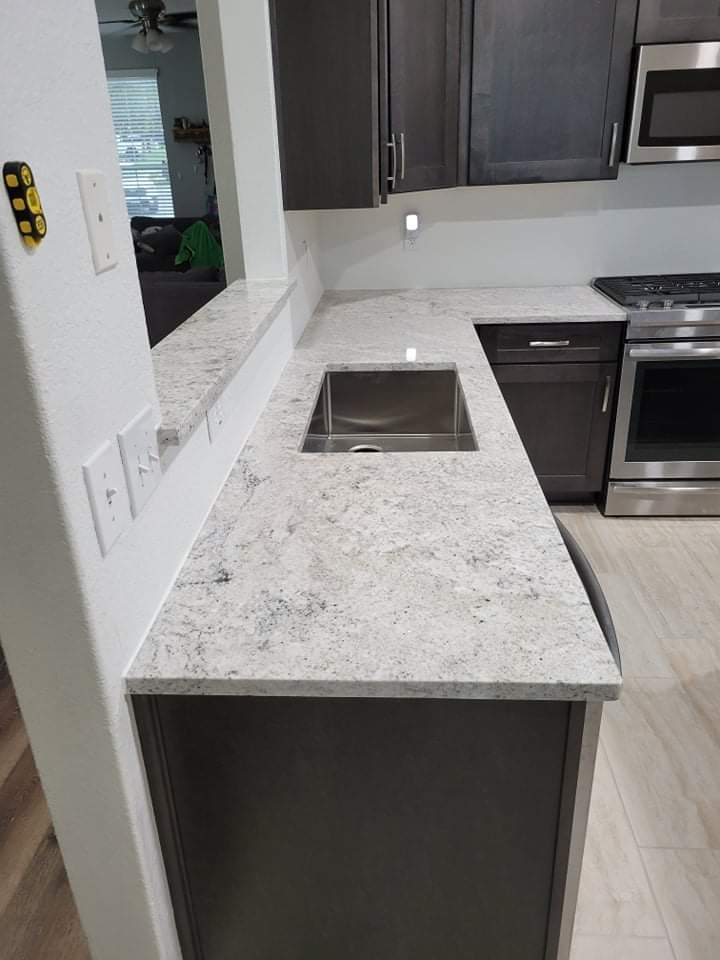Kitchen countertops using Salinas White Granite  by Mena stone surfaces