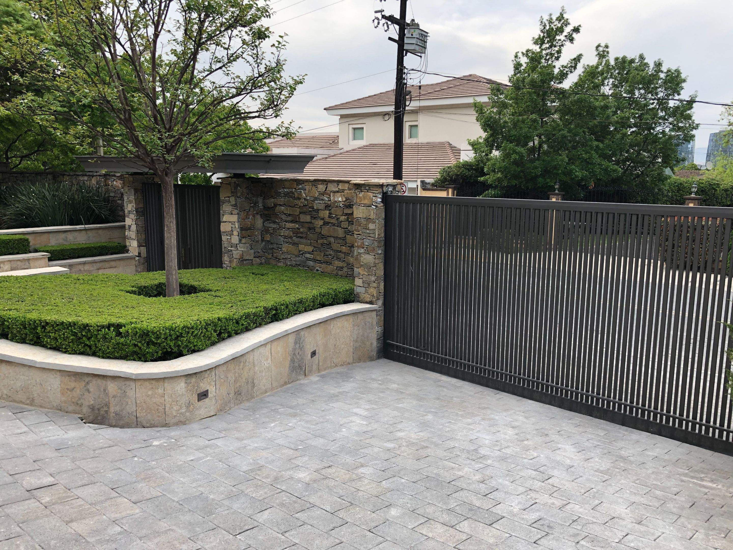 Custom Stone Entryway and Secure Perimeter Gate Installation in Monterrey by Solara Custom Living