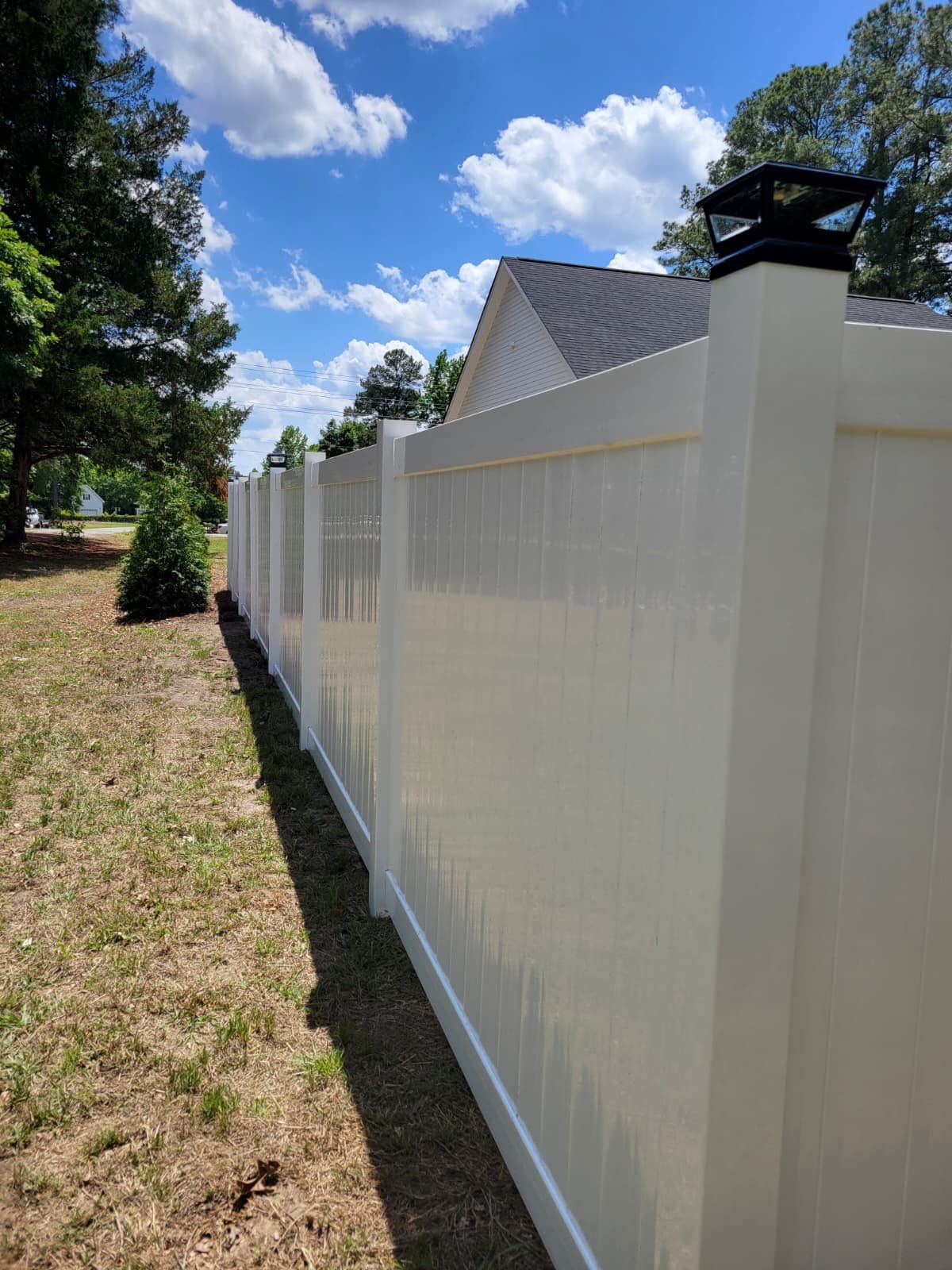 White Vinyl Privacy Fence with Solar Post Caps in Goldsboro by Superior Fence and Rail