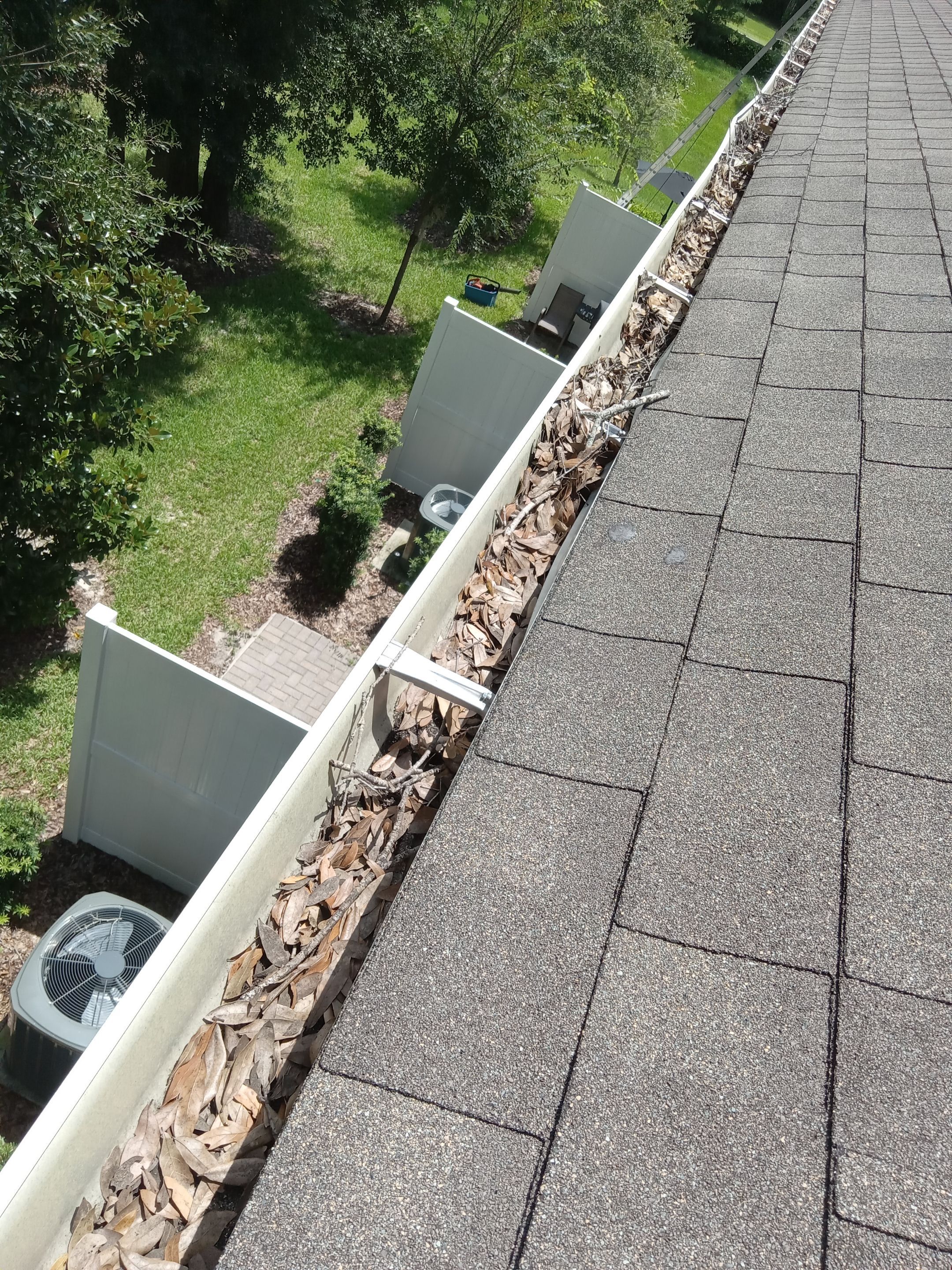 Commercial gutter cleaning Sanford & Lake Mary, FL before photo with filled gutters