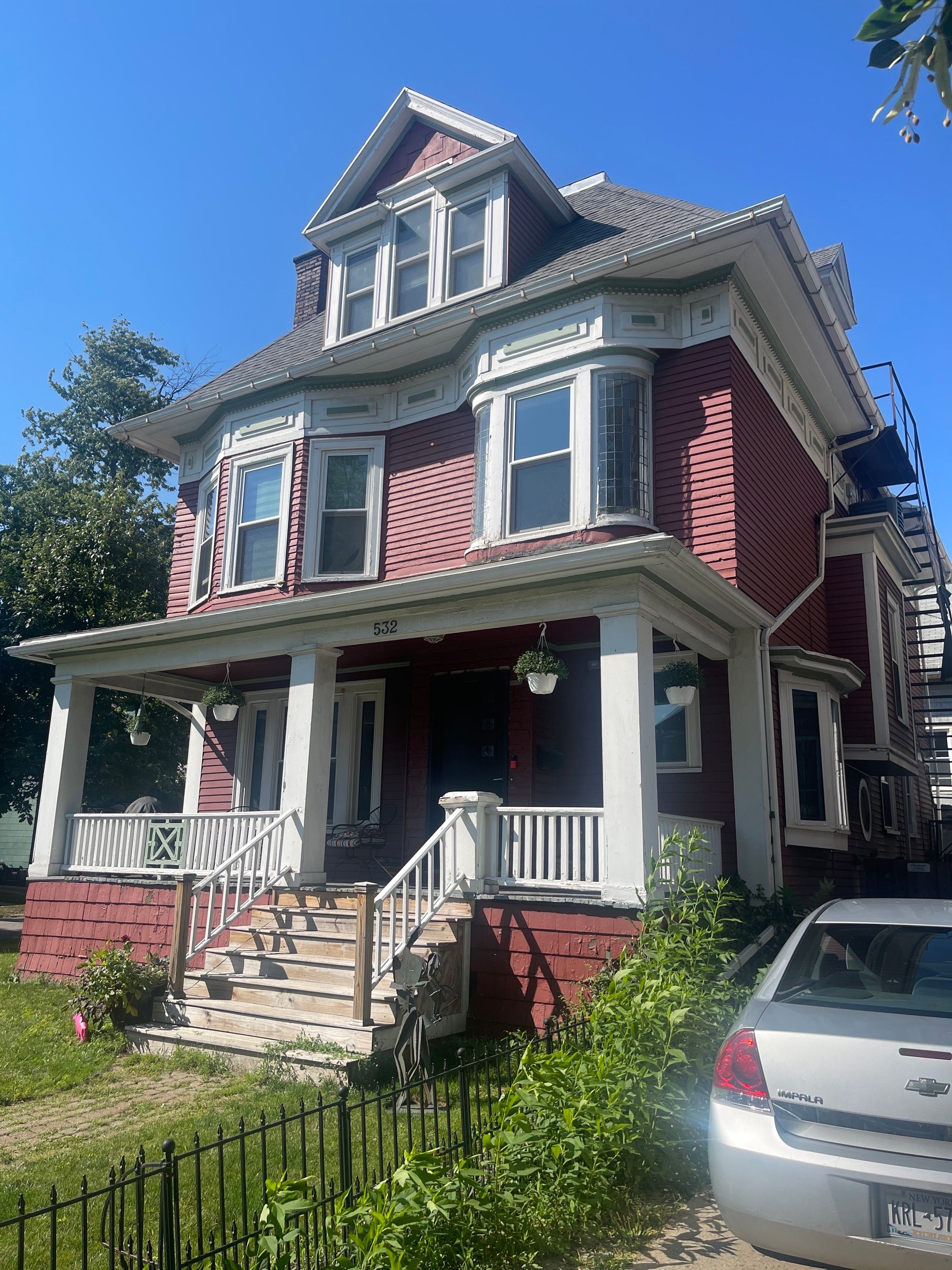 Exterior Renovations- Siding, Stamped Concrete, Porch, and Railings by Ivy Lea Construction