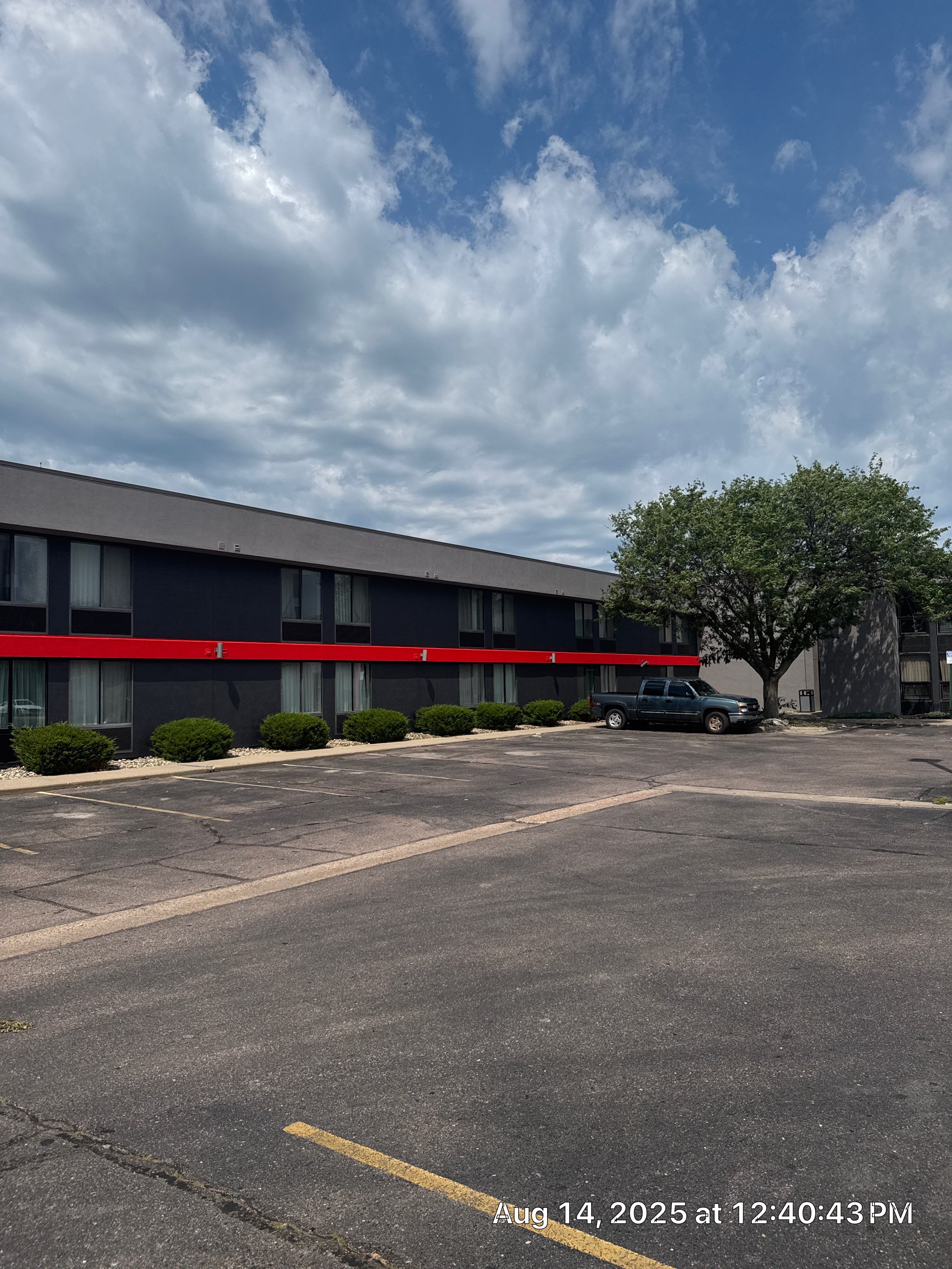 Commercial Exterior Painting with Stucco and Bold Red Accent Trim by Select Painting, Coatings & Garage Cabinets