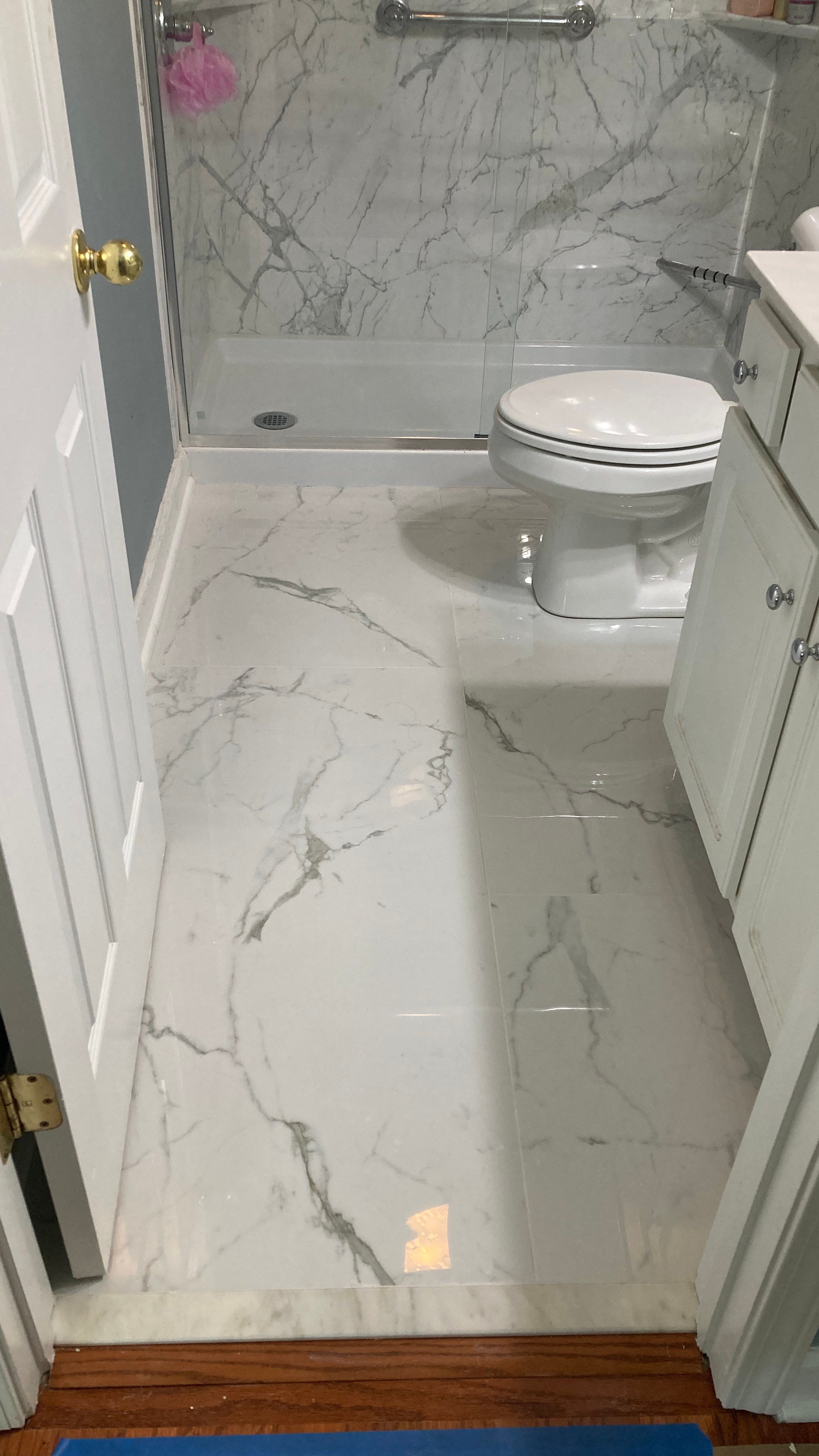 Lovely marbled bathroom floor  by Footprints Floors of Nashville
