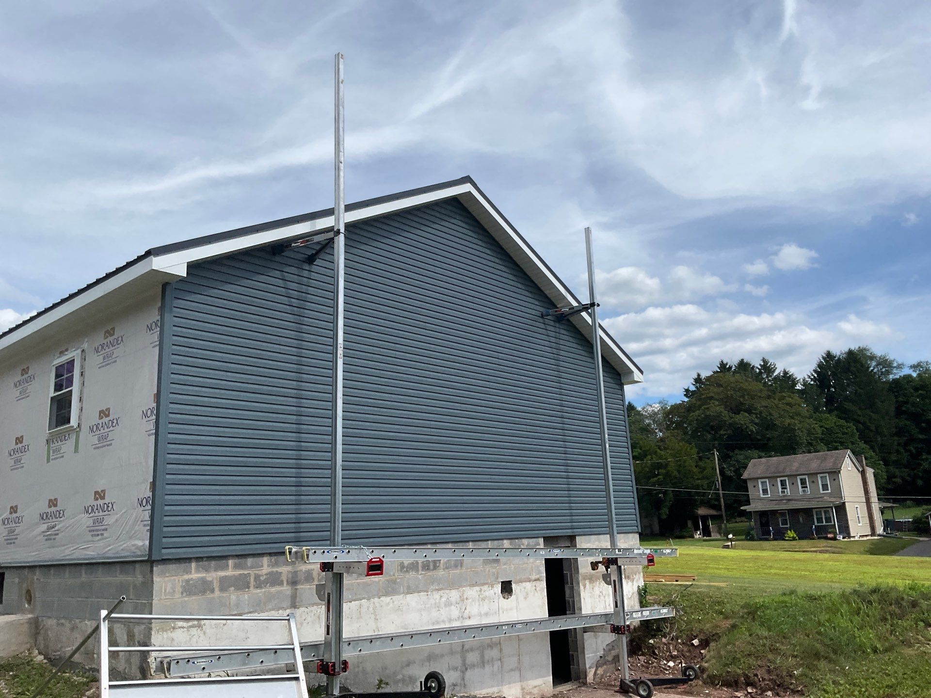 New Residential Addition with Blue Siding and Metal Roofing in Ashland by Esh Builders