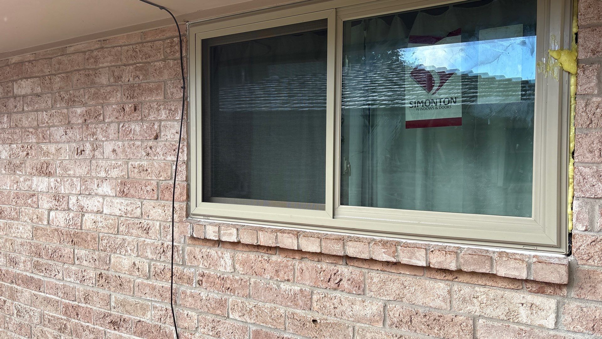 Colored Vinyl Windows to blend into brick by Bayfront Roofing and Construction