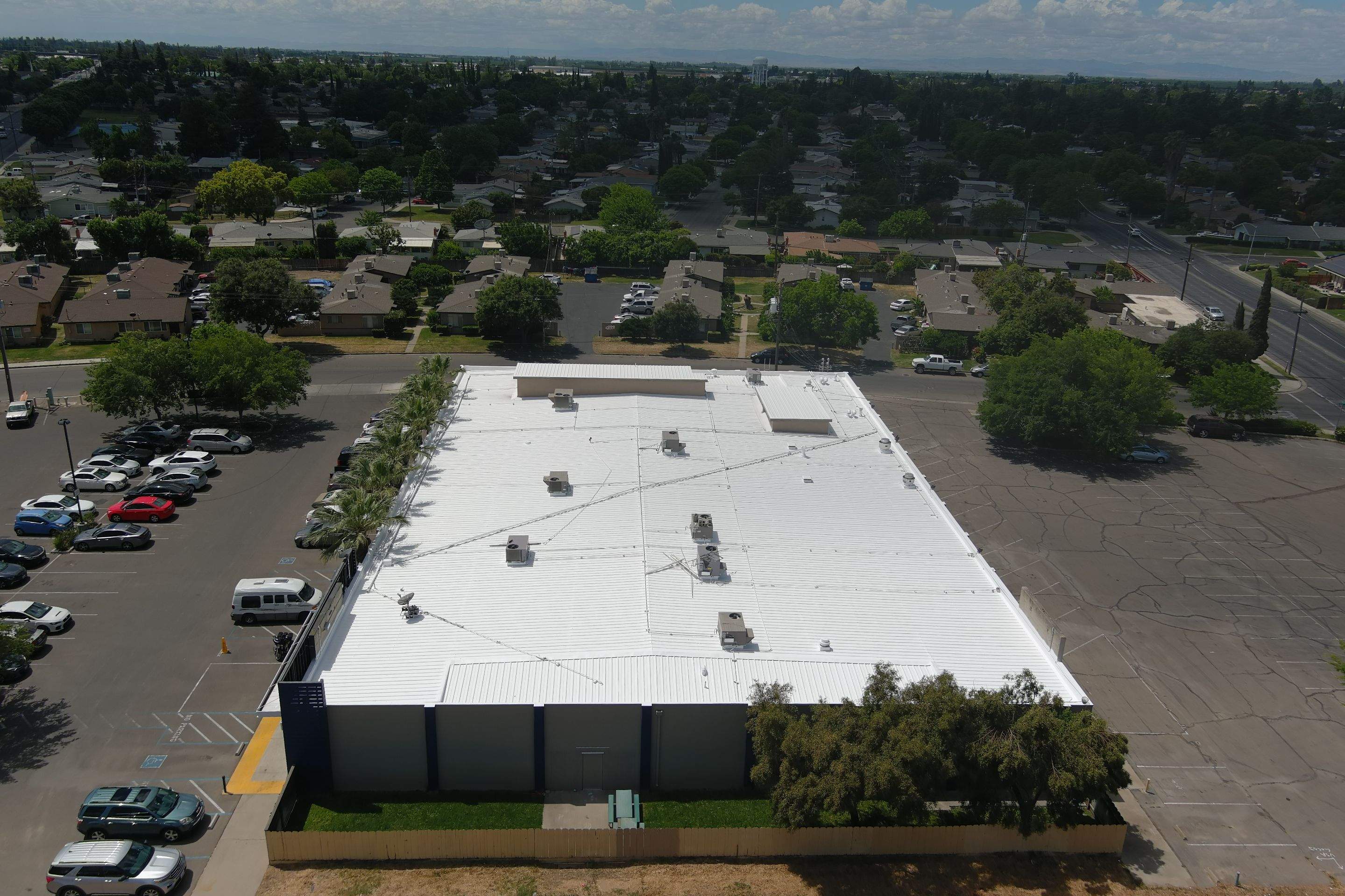 Metal roof restoration on commercial roof using Conklin Benchmark/ PUMA XL acrylic coatings over metal and foam by Straight Edge Roofing Inc