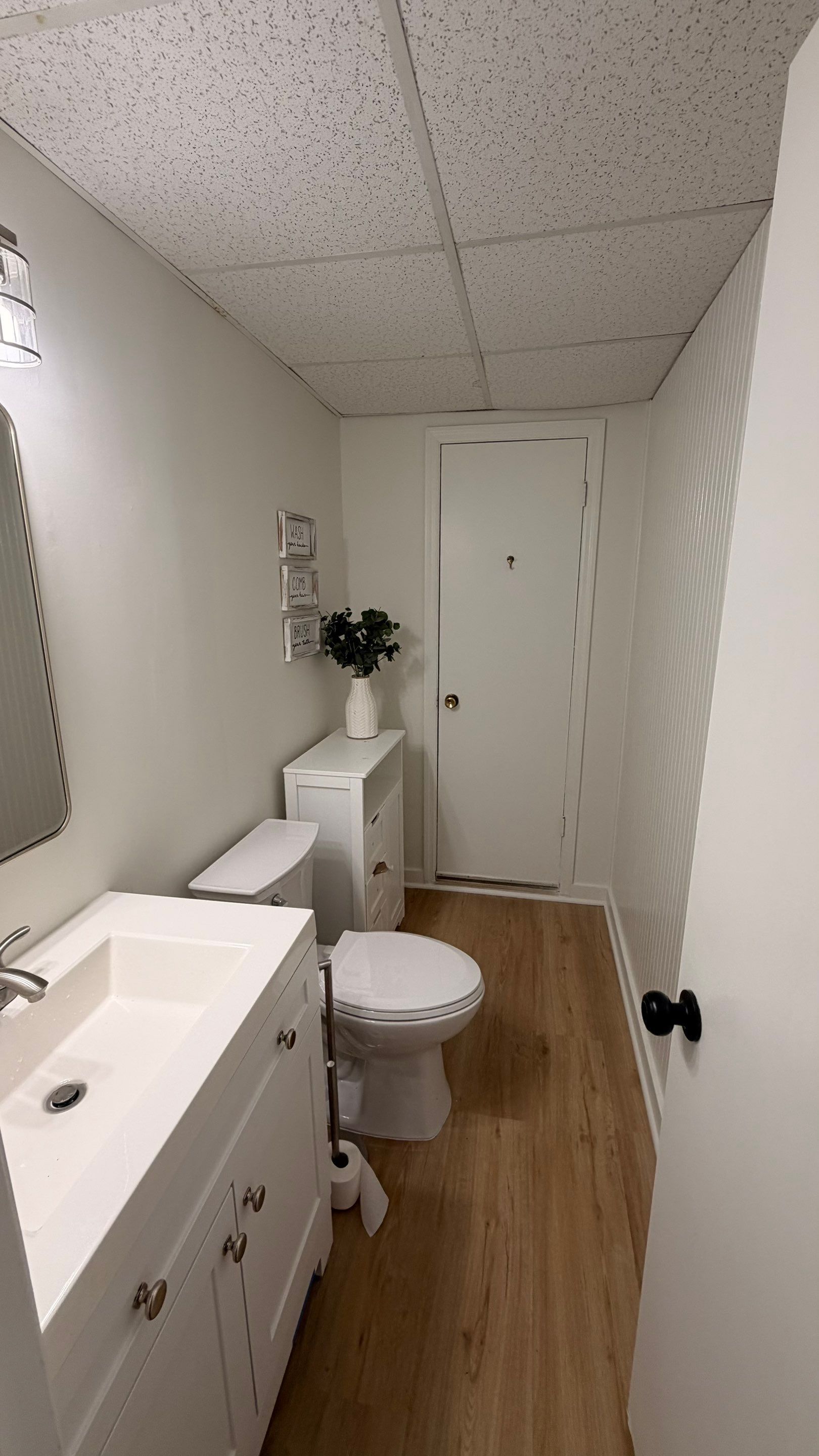 Basement Remodeling with Wood-Look Flooring and Custom Wainscoting in Dunwoody by Swift Home Renovations