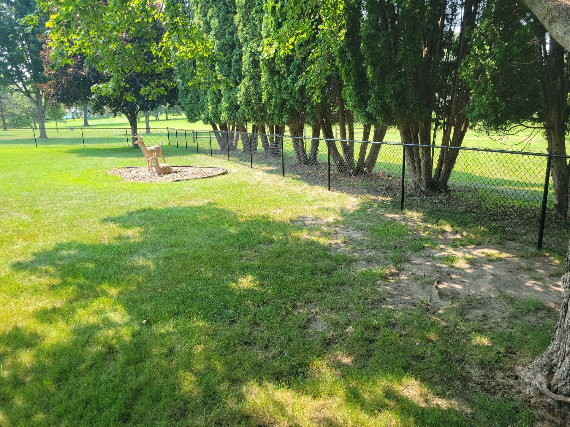 Black Vinyl-Coated Chain Link Fence Installation in New Hampton by Perfect Picket Fence and Stain