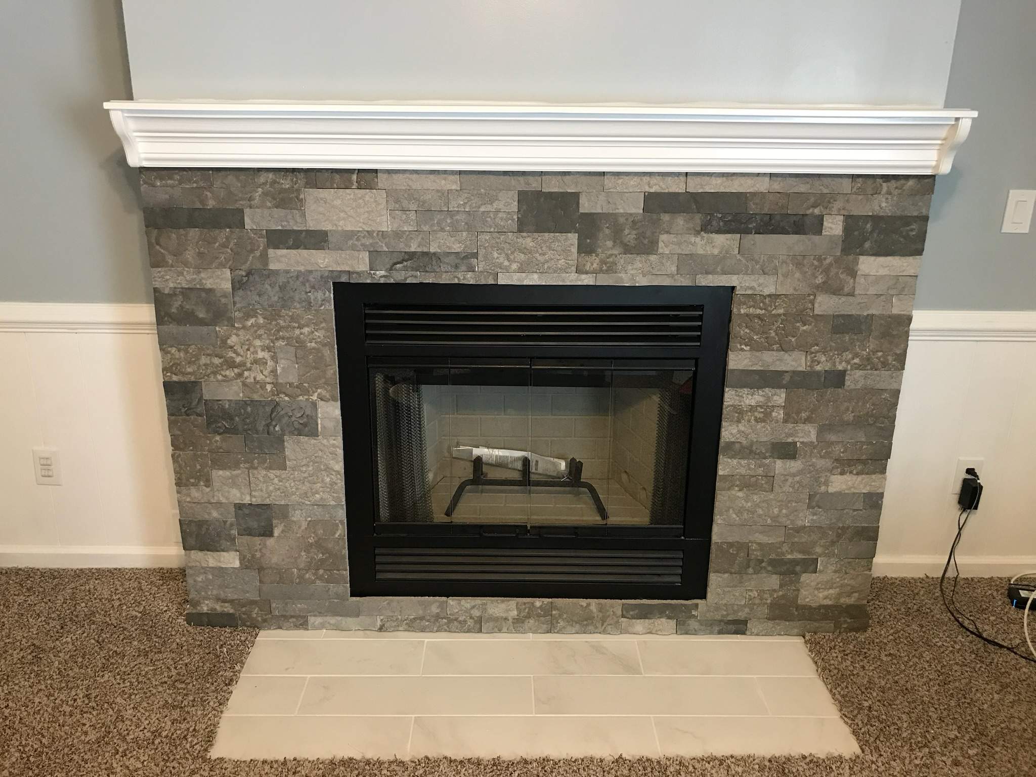 Wood Fireplace + stone + mantel by Premier Chimney and Roofing