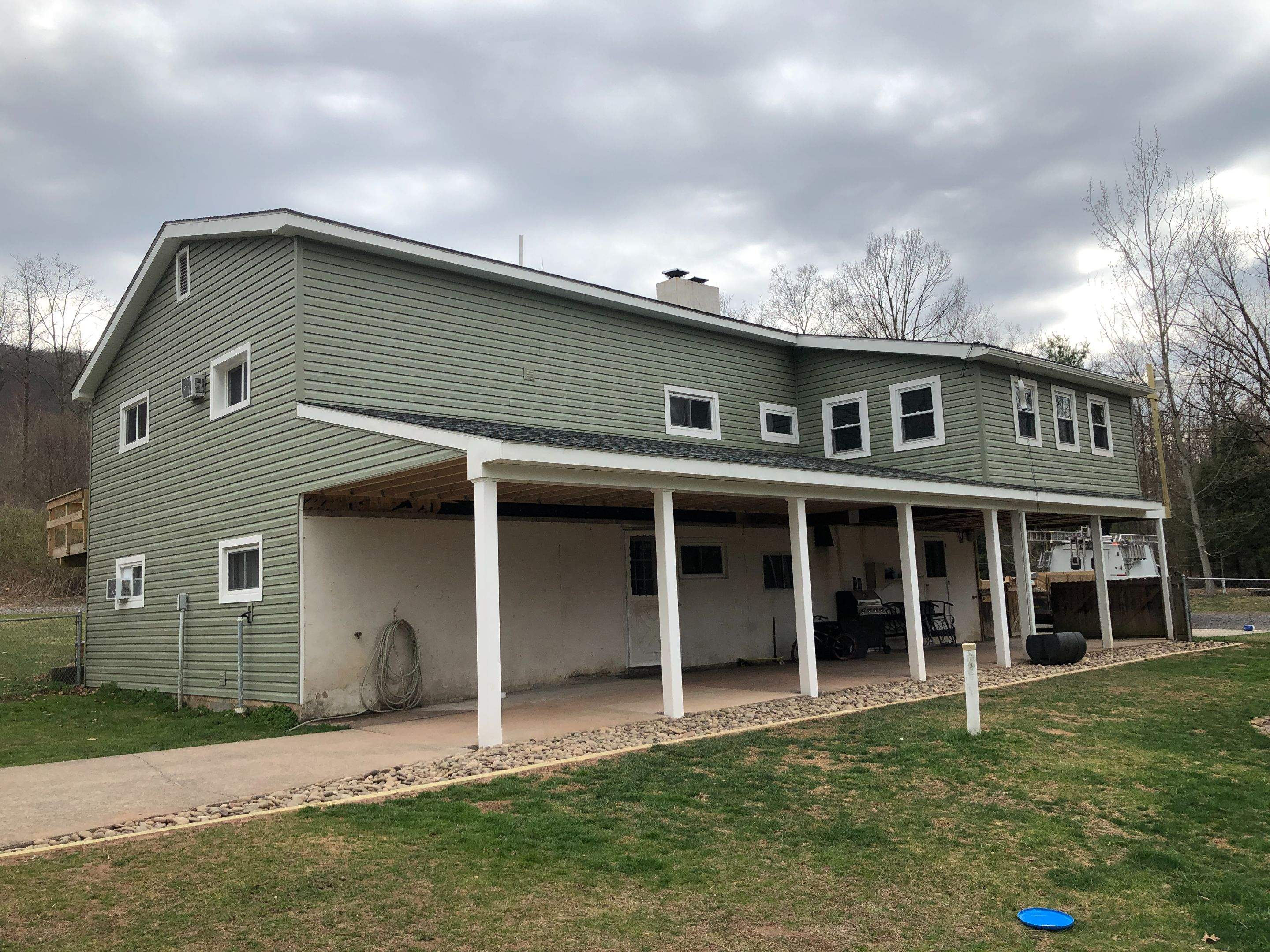 Sage Green Vinyl Siding and Exterior Trim Replacement in Ashland by Esh Builders