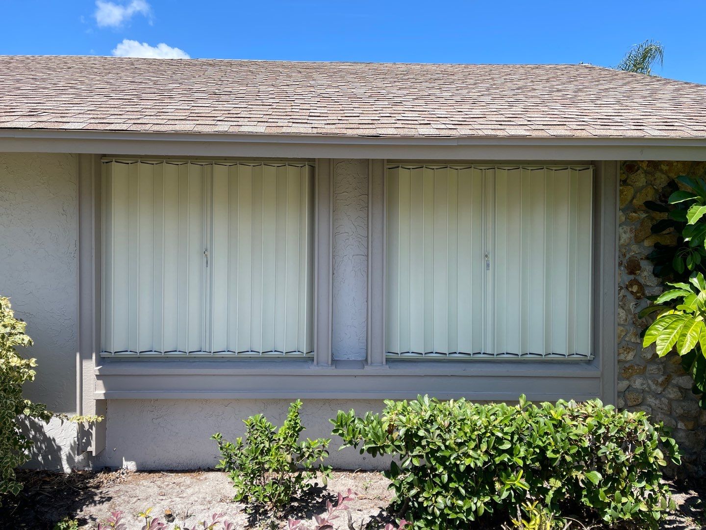 Ivory accordion shutters by Smart Guard Shutters