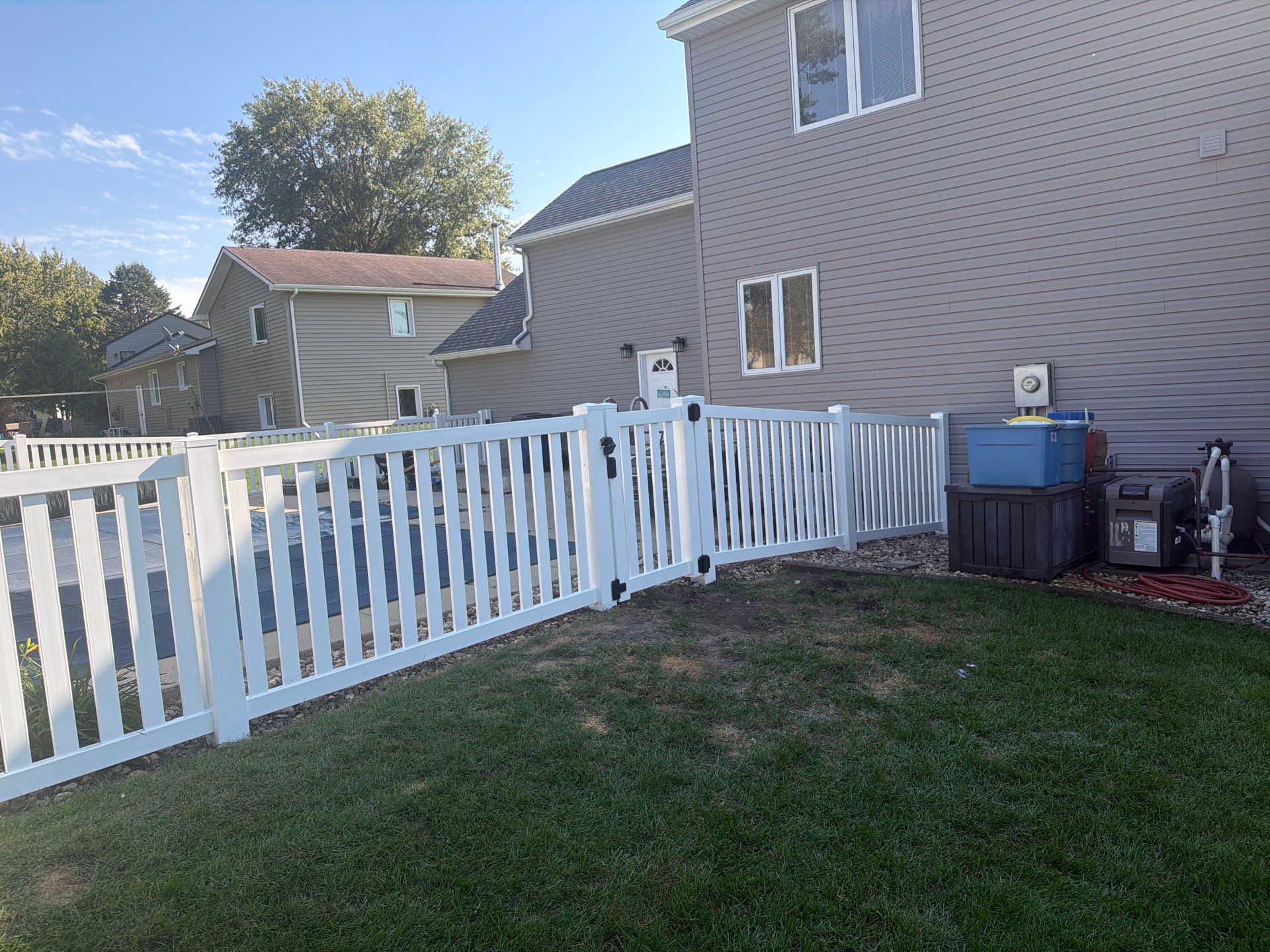 White Vinyl Picket Pool Fence Installation in Waterloo, Iowa by Perfect Picket Fence and Stain