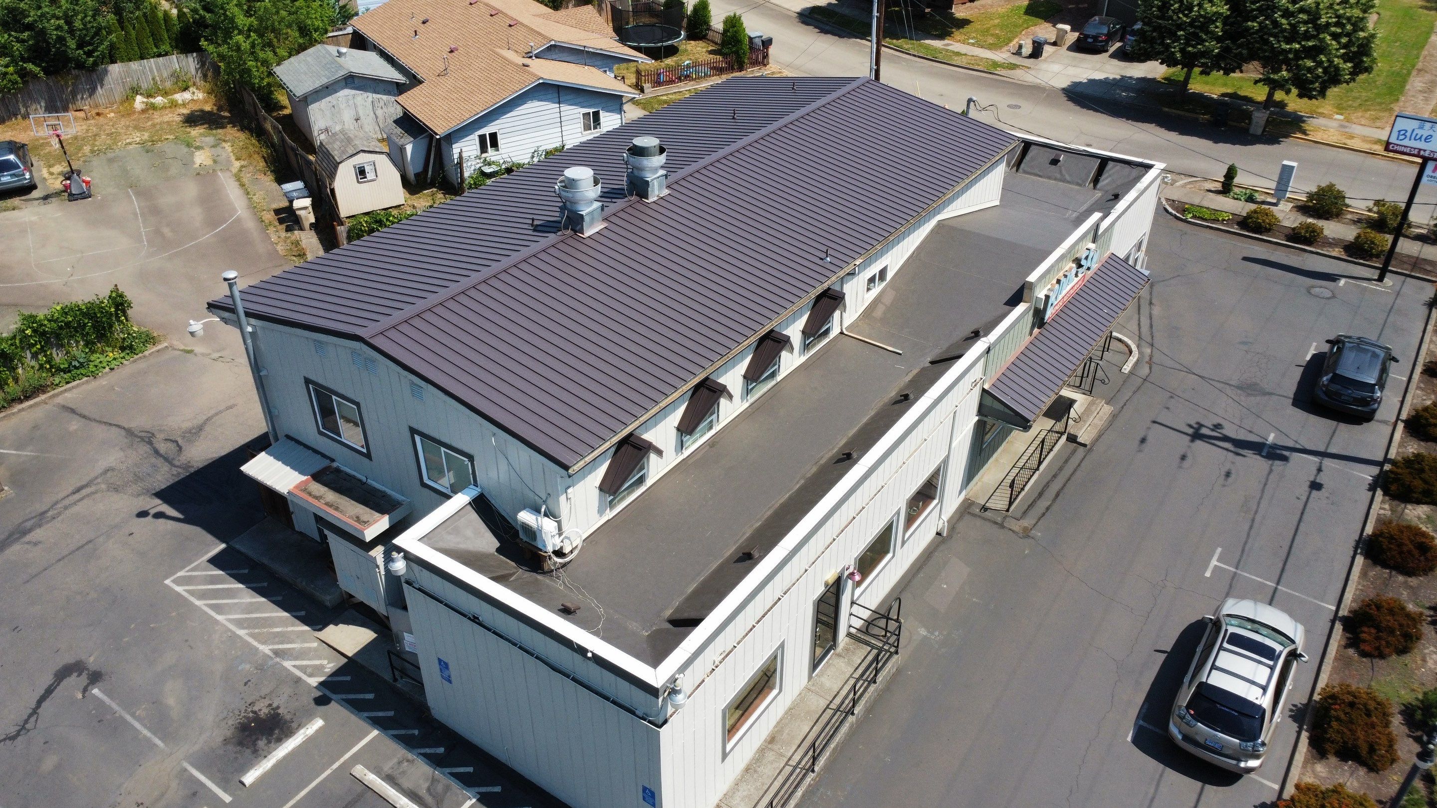 Commercial Flat Roof Installation using Bruce and Dana Snap Lock Metal (Color: Brown) by Orezona Building & Roofing Company, Inc.