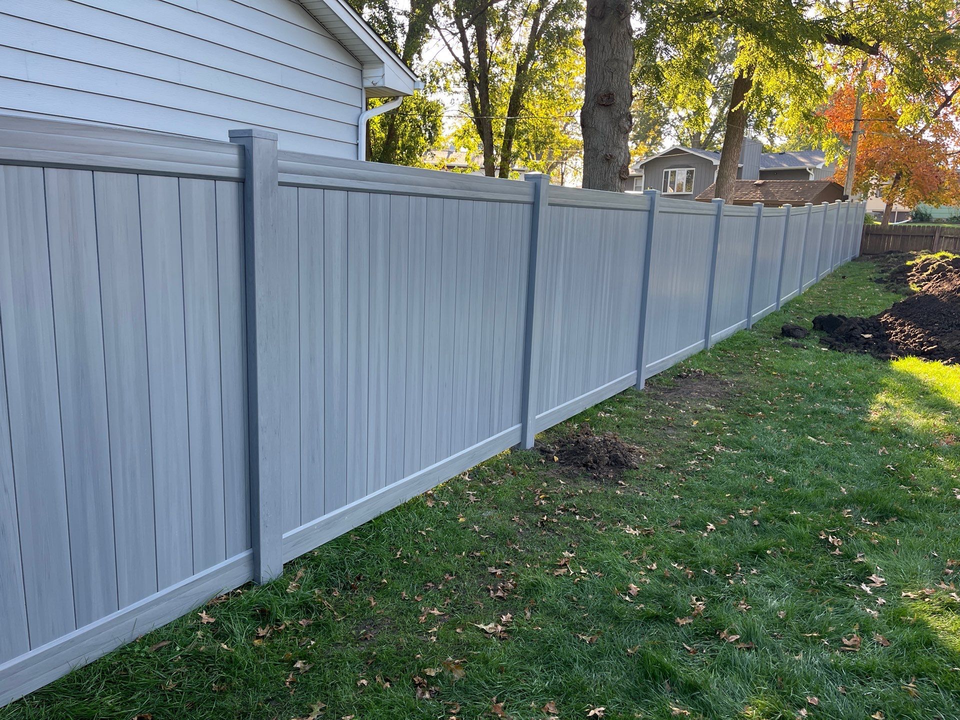 Chai Gray Vinyl Privacy Fence and Gate Installation in Cedar Falls by Perfect Picket Fence and Stain