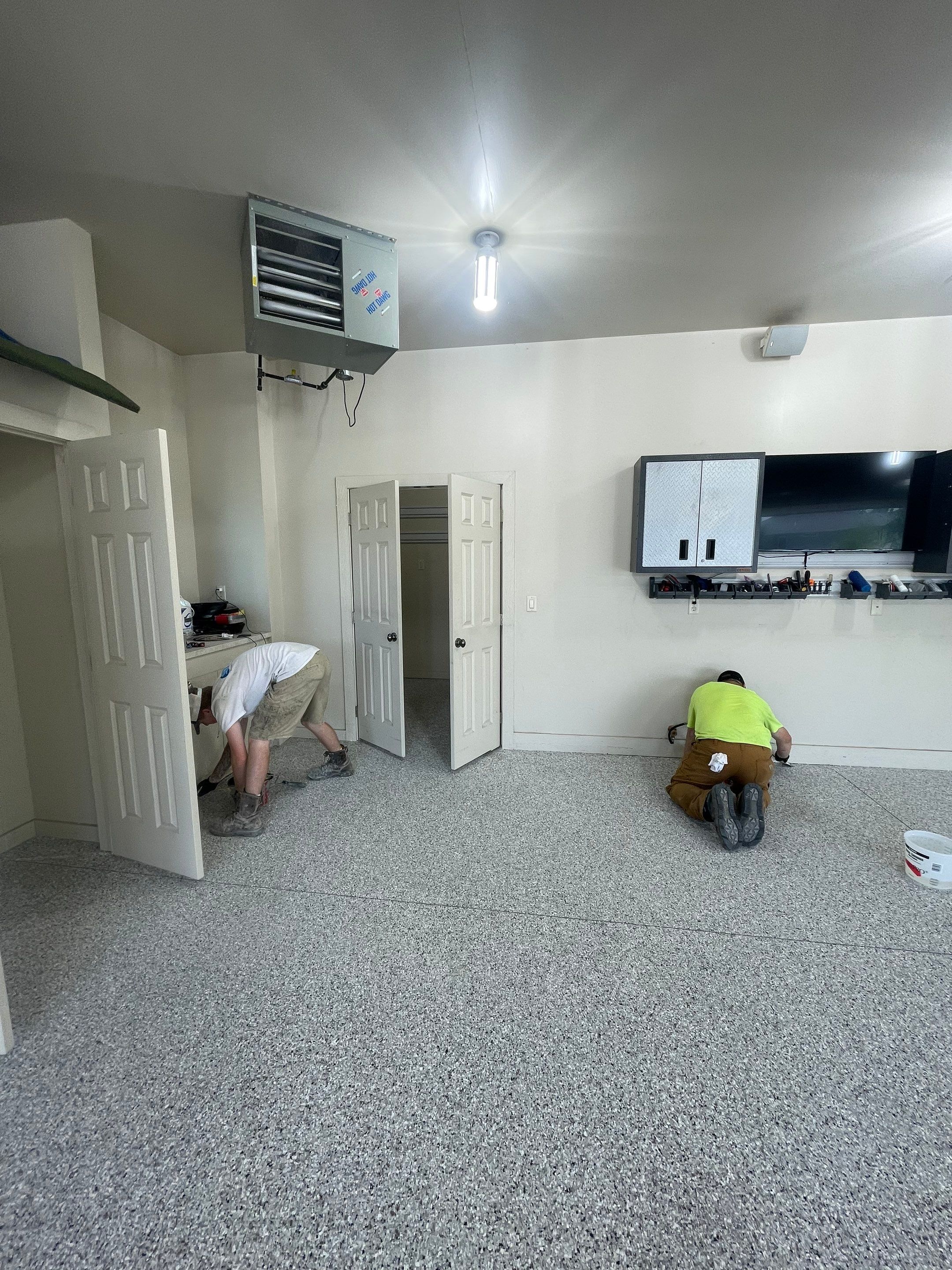 Coyote Flake Garage Floor Coating in Sioux Falls with Trench Drain by Select Painting, Coatings & Garage Cabinets