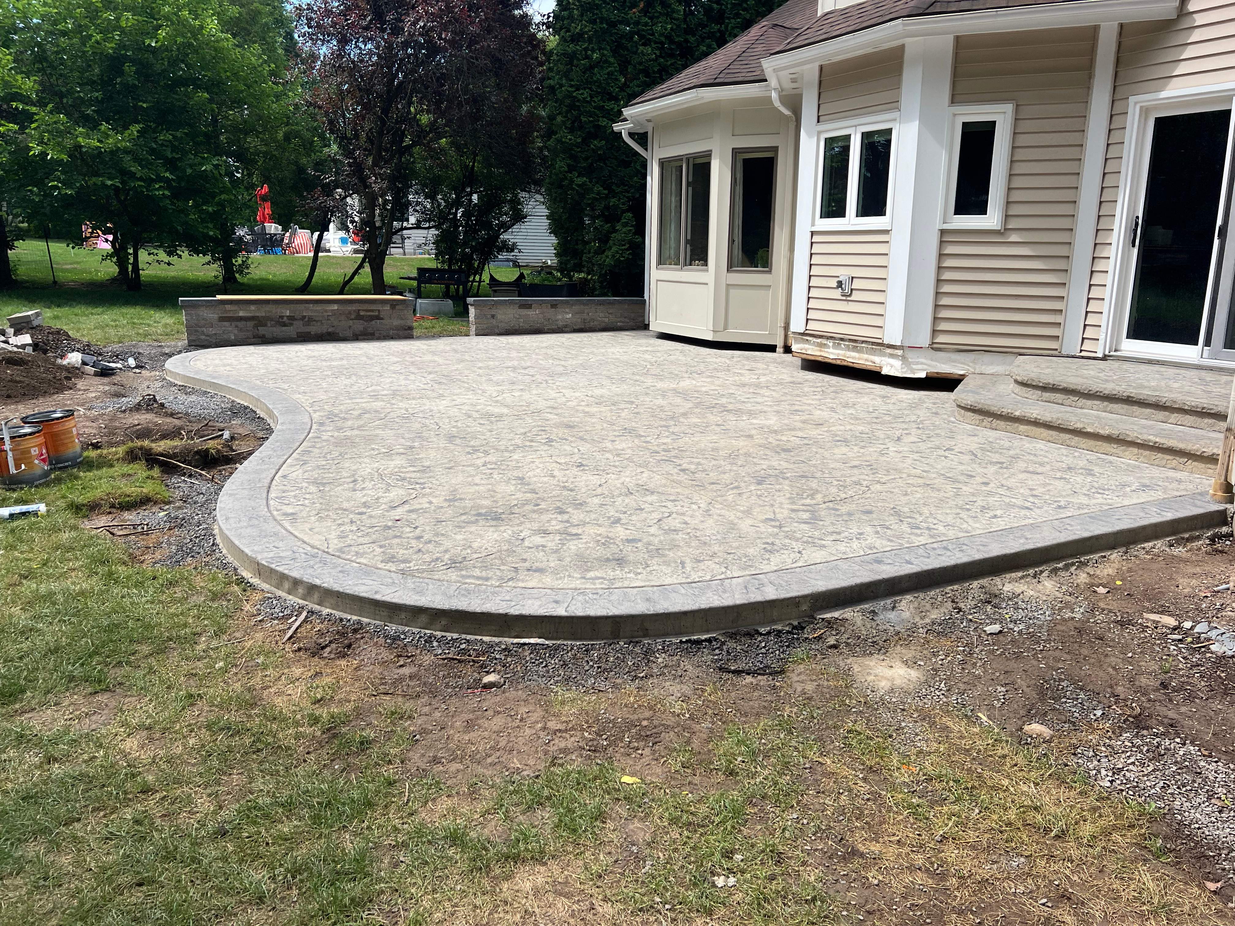 Heavy stone stamped concrete patio and sidewalk  by NG Masonry & Construction LLC