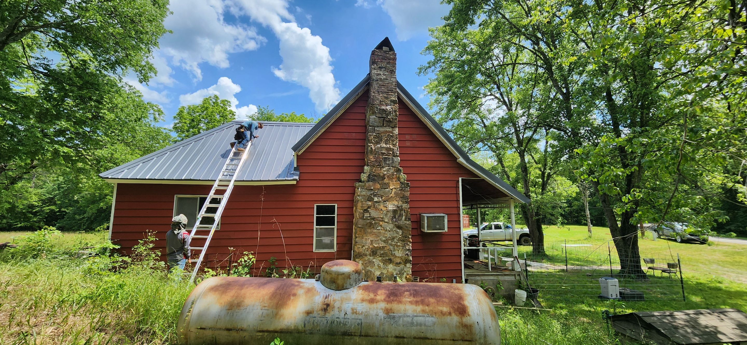 Residential Roofing Installation using 26 Gauge Colored Panels by Hostetler Roofing