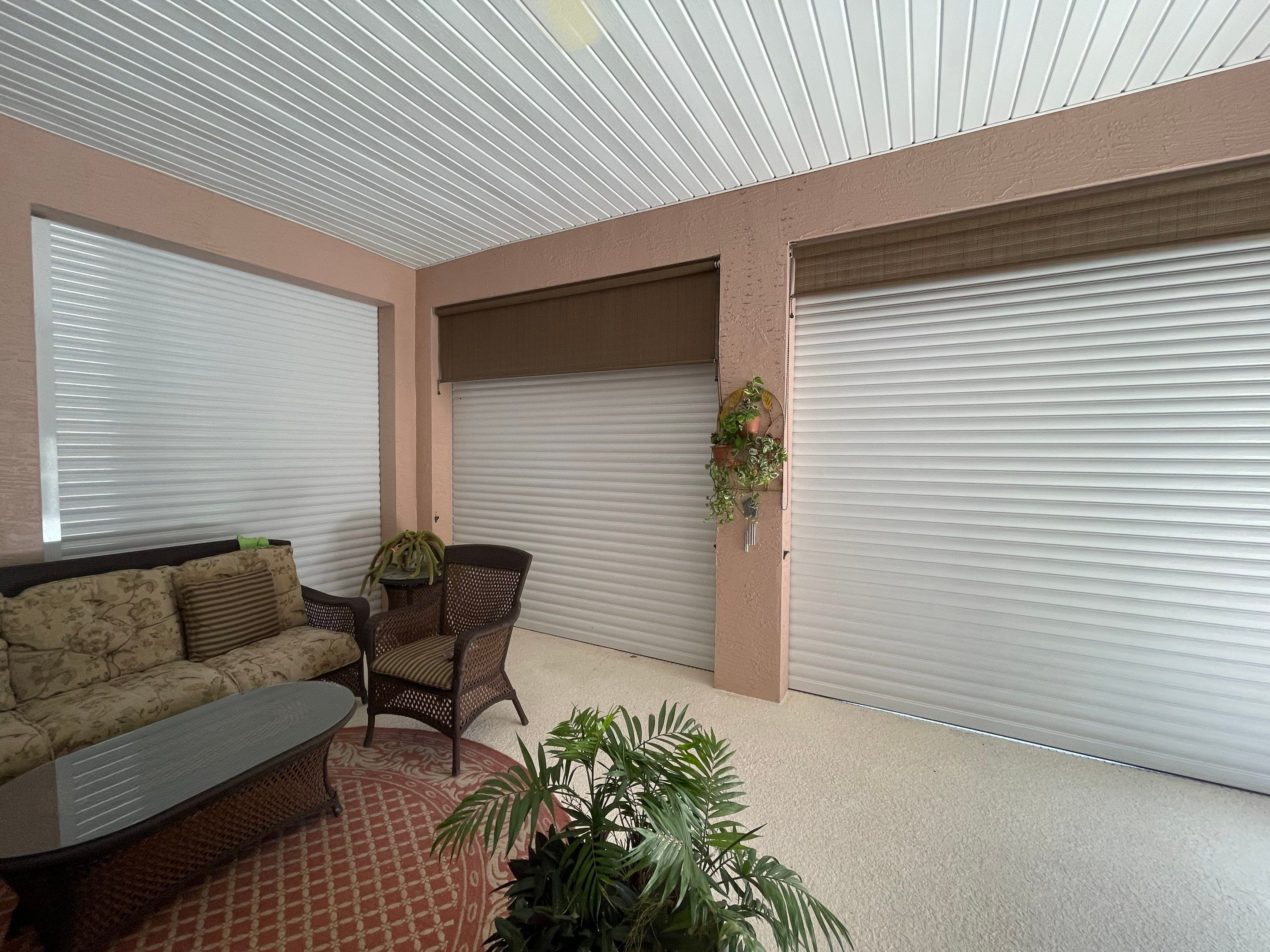 Motorized shutters on lanai by Smart Guard Shutters