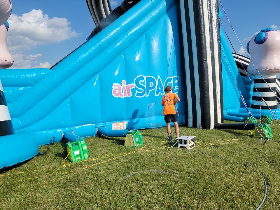 Cleaning for big bounce america prior to a large event by Northern Power Washing LLC.