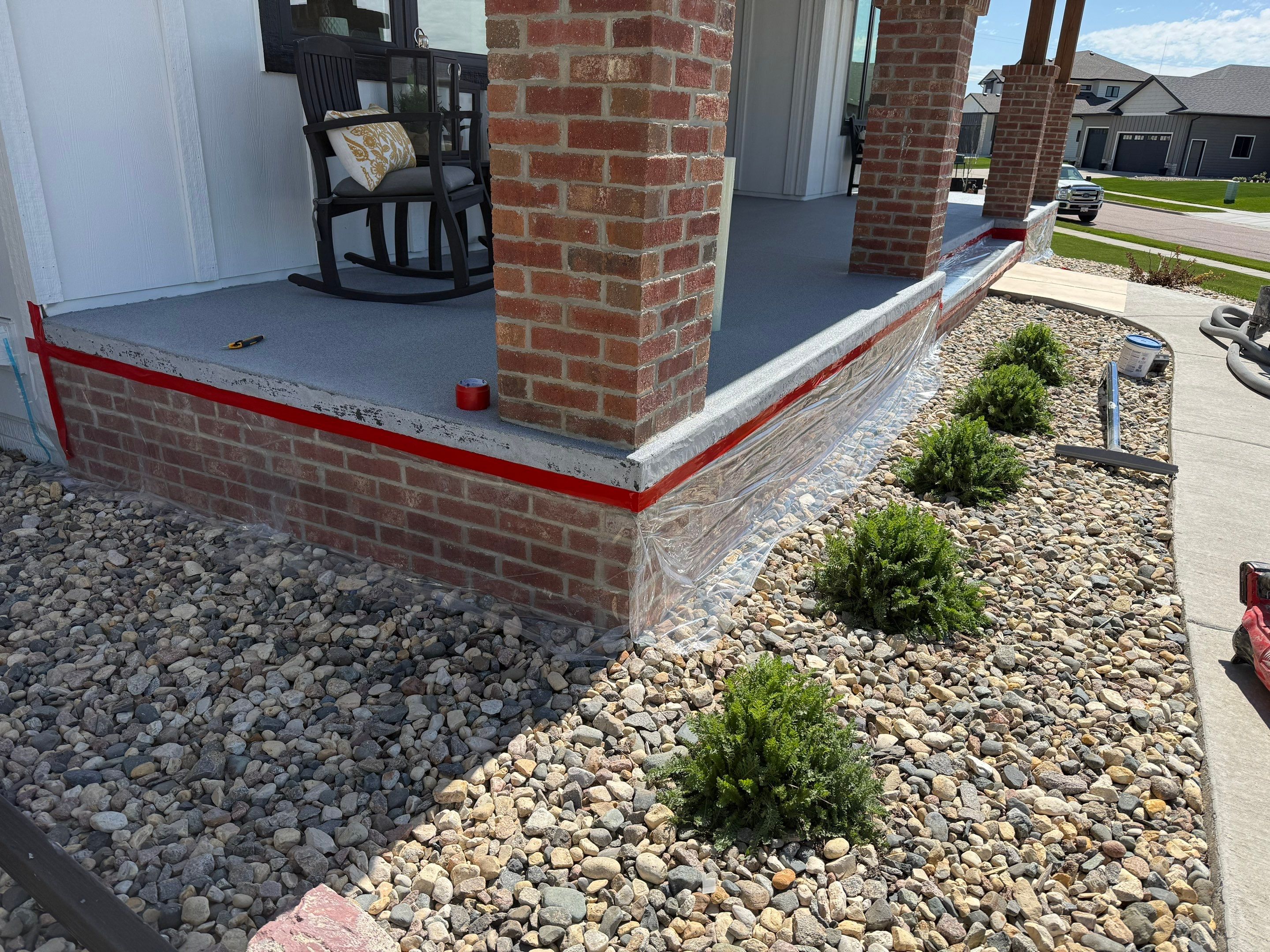 Grey Speckled Concrete Porch Coating for Sioux Falls Home by Select Painting, Coatings & Garage Cabinets