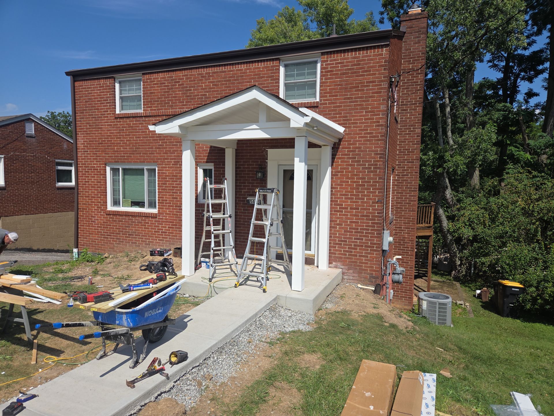 Concret and roof build  by Cousins Roofing Siding & Decks