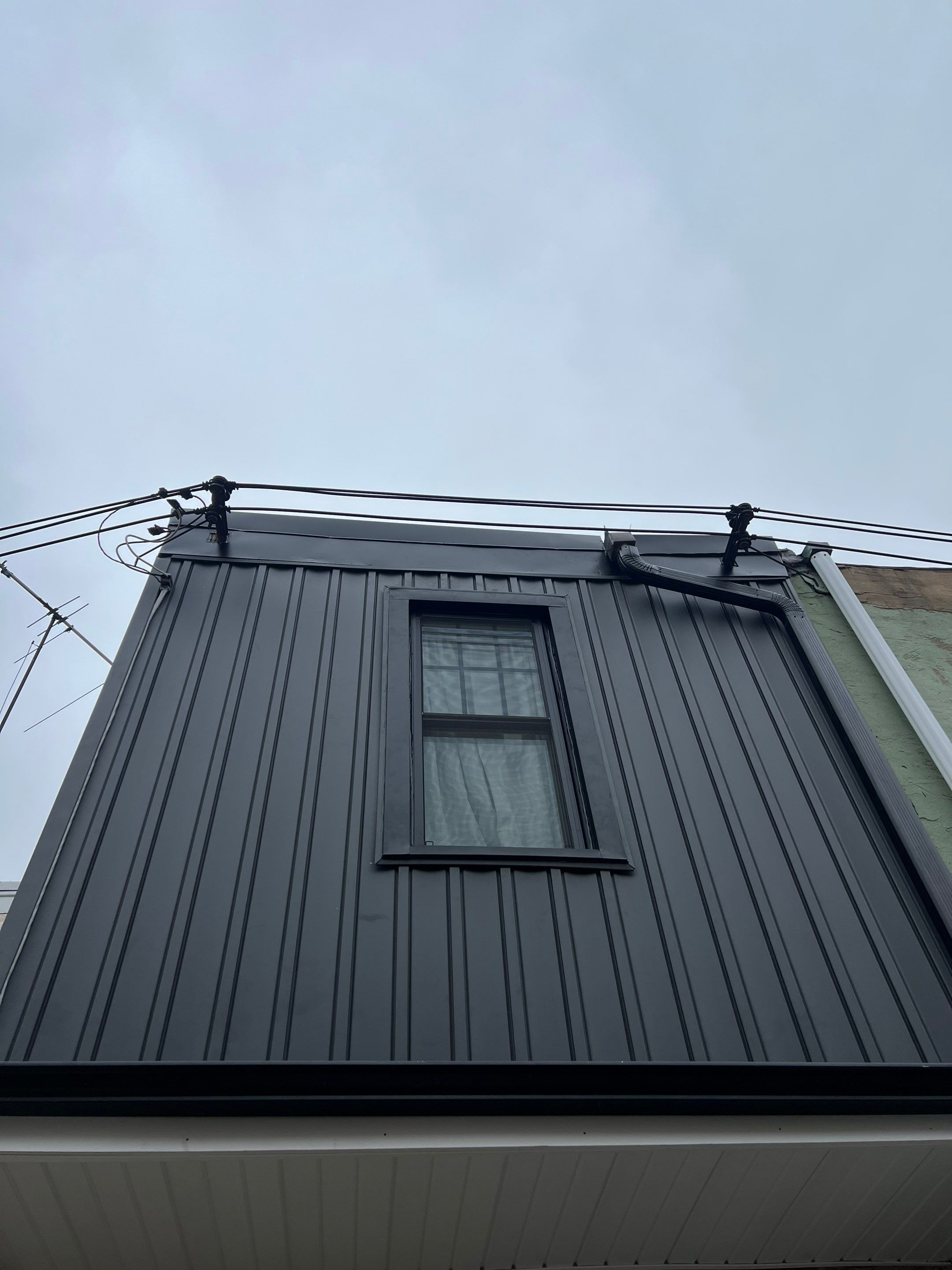 Vertical Black Metal Siding Installation for Philadelphia Home Exterior by Hybrid Roofing And Renovations