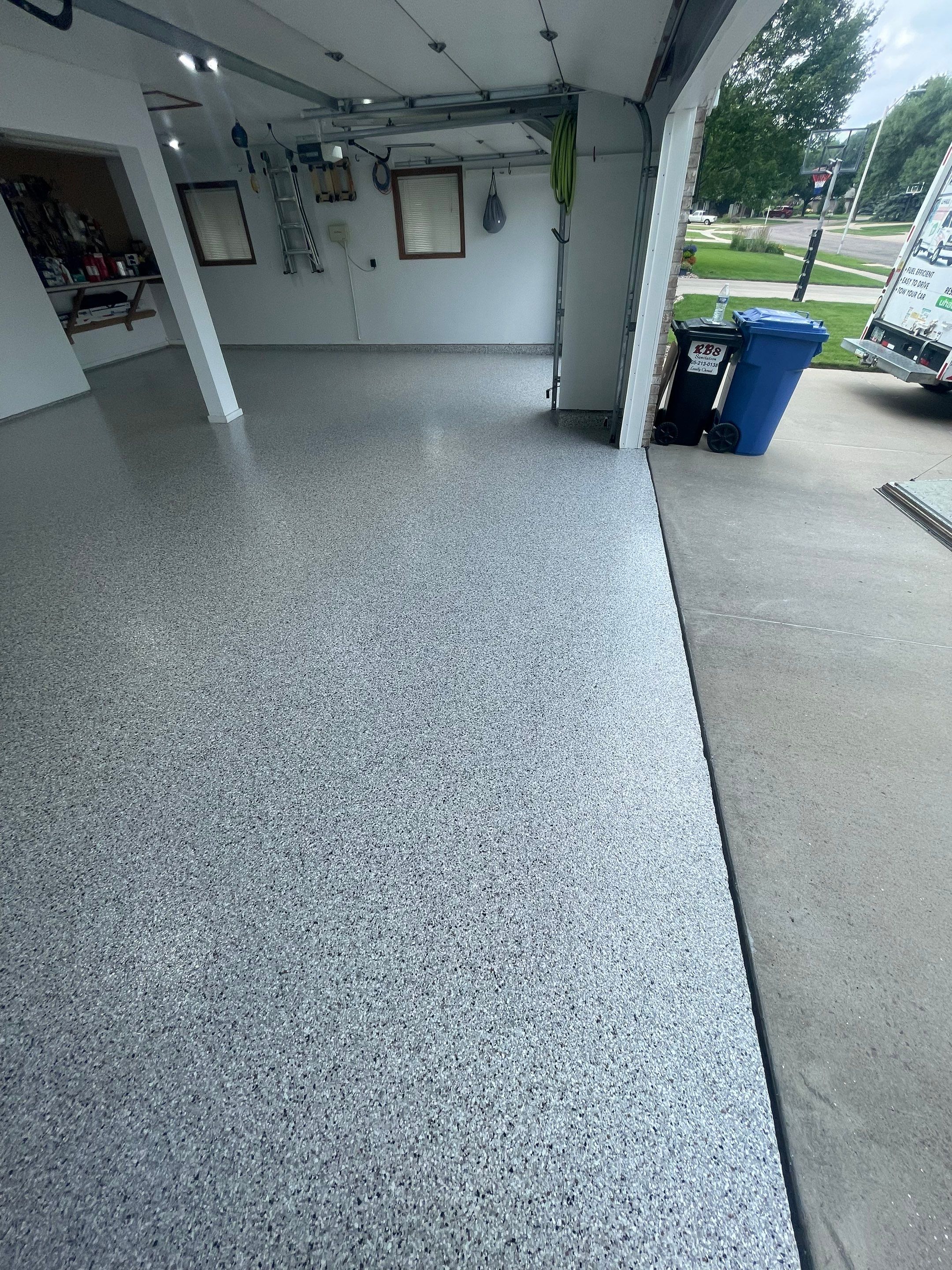Multi-Car Garage Concrete Coating with Coyote Flake Finish in Sioux Falls by Select Painting, Coatings & Garage Cabinets