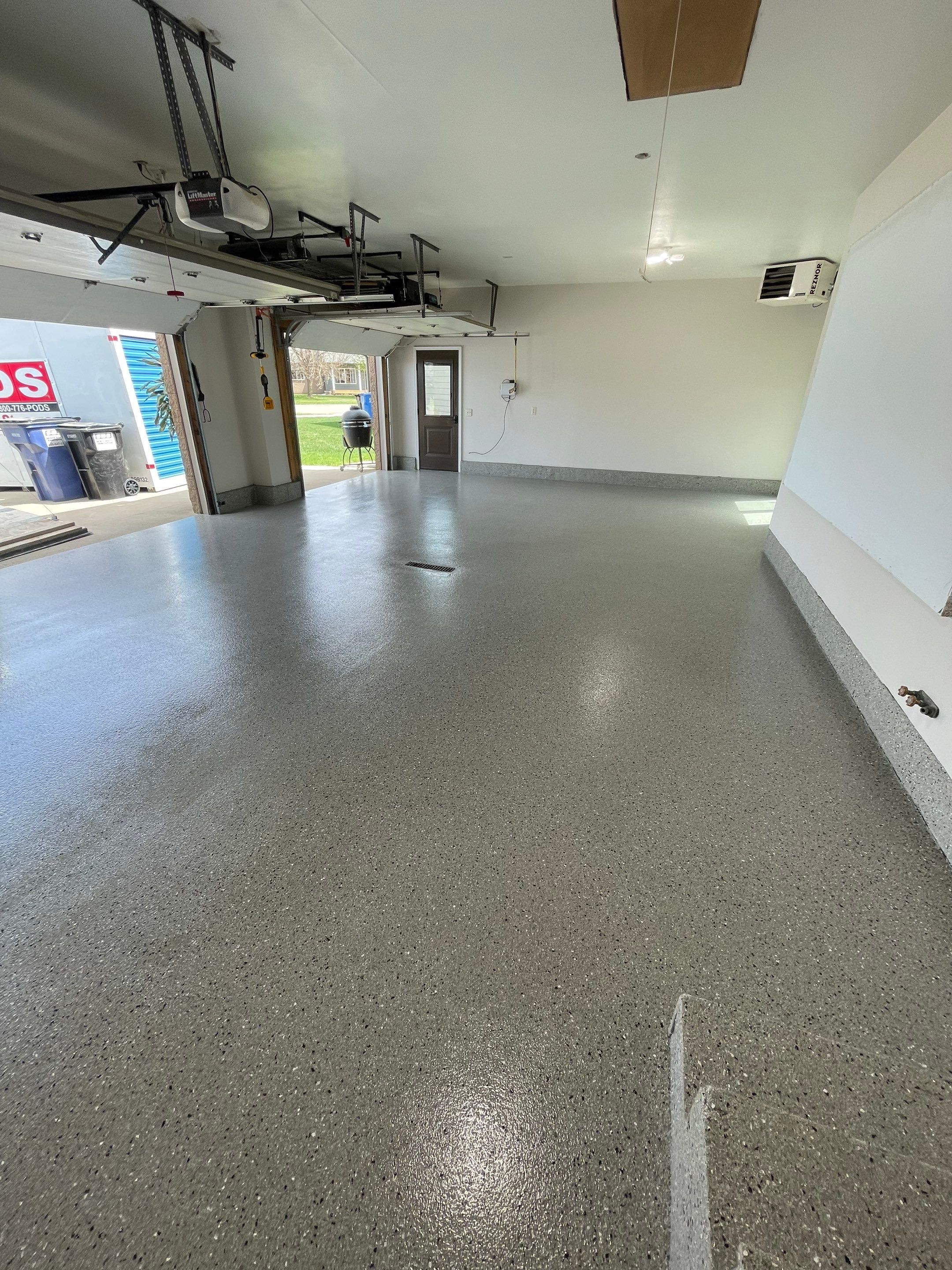 Residential Garage Floor Coating with Grey Speckled Epoxy Finish by Select Painting, Coatings & Garage Cabinets