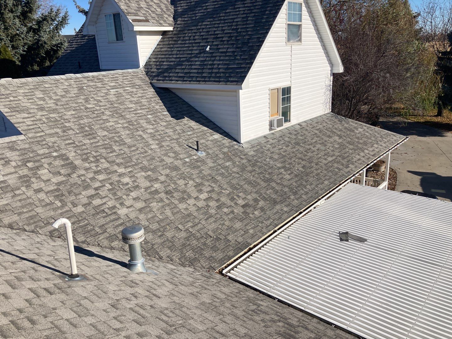 Two story farmhouse style roofing installation using Owens Corning Duration in the color Teak by ID Roofing LLC