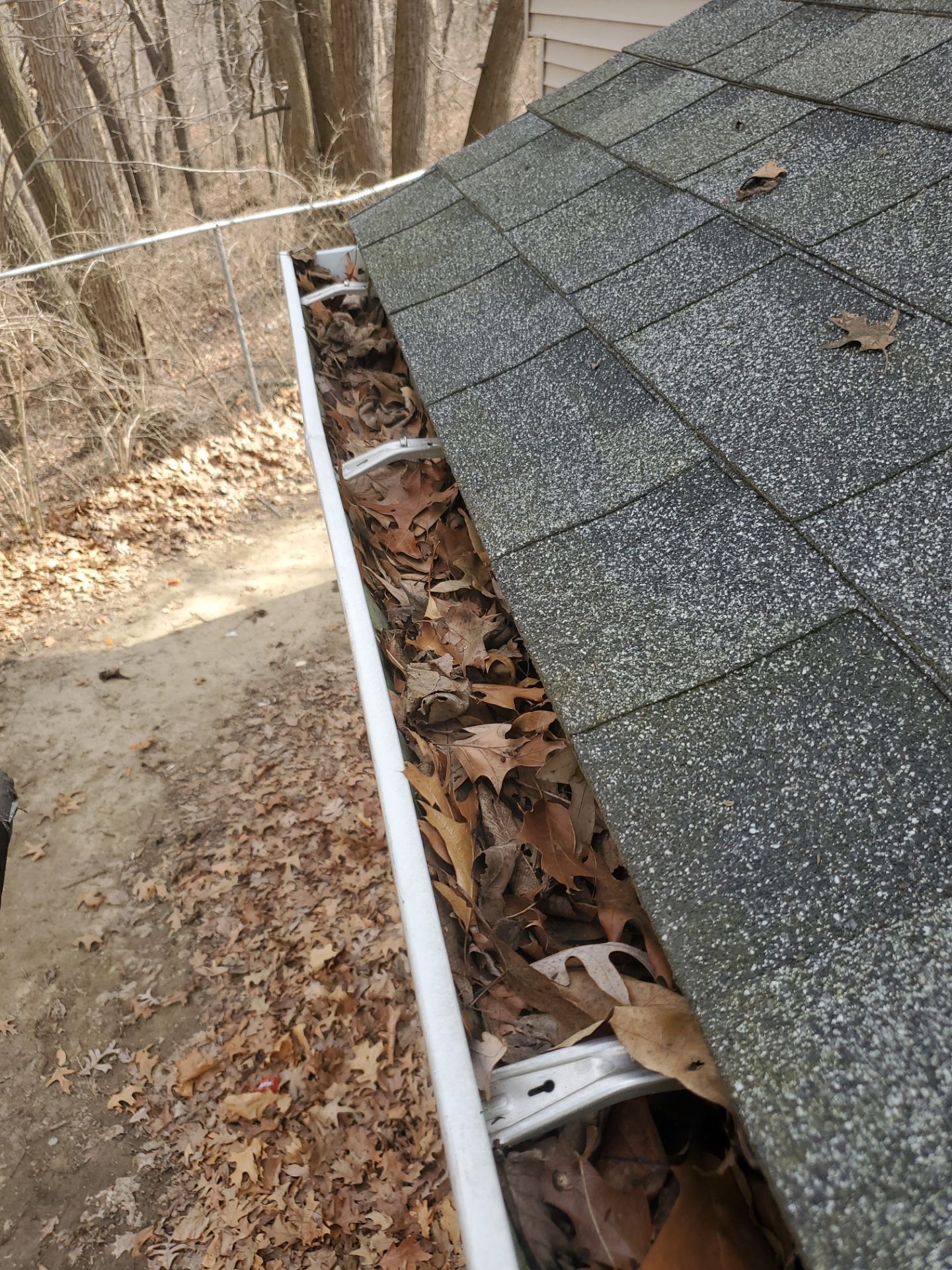 Commercial gutter cleaning Peoria, IL before photo with filled gutters