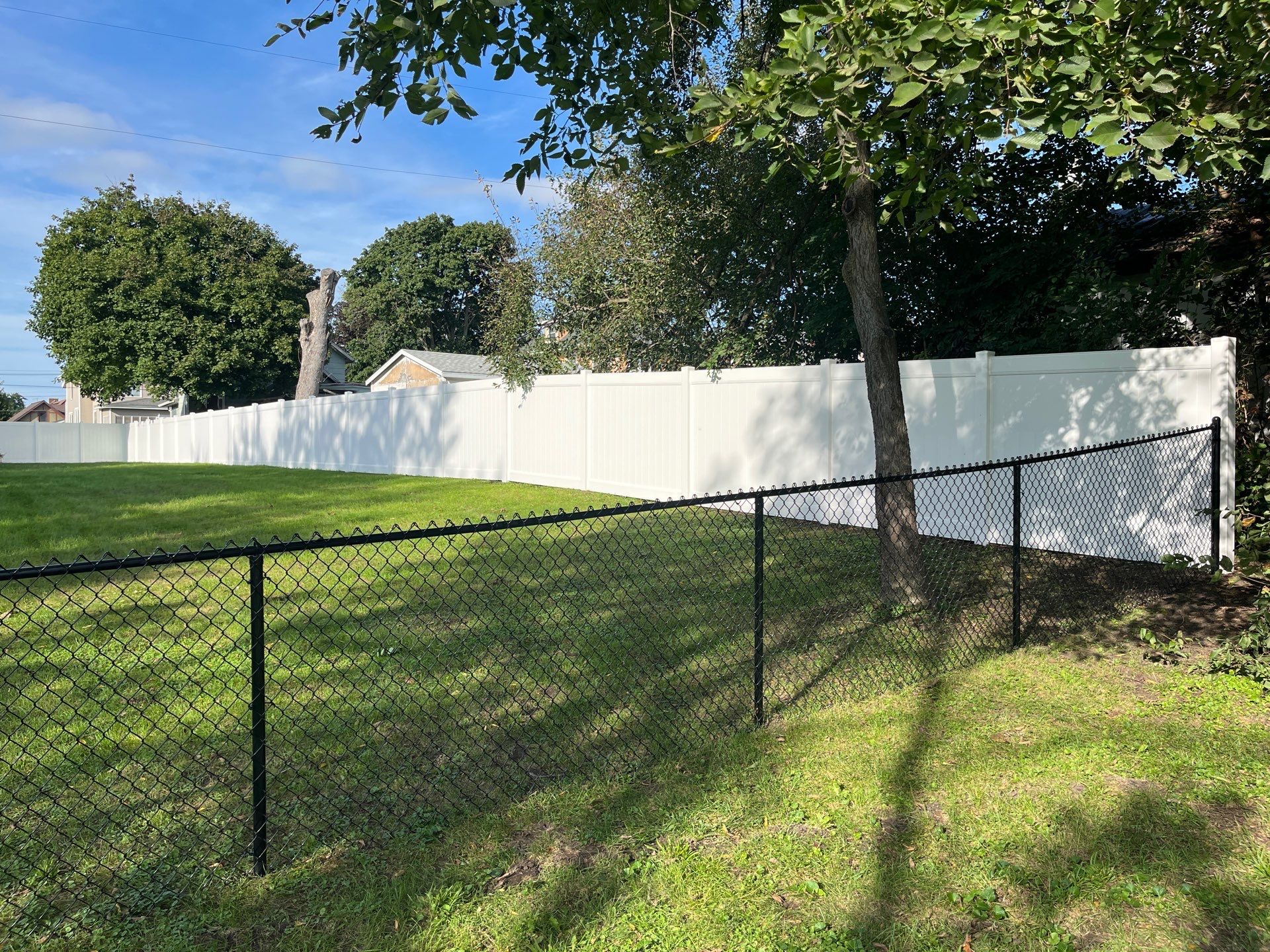 White Vinyl Privacy Fence and Black Chain Link Installation in Sumner by Perfect Picket Fence and Stain