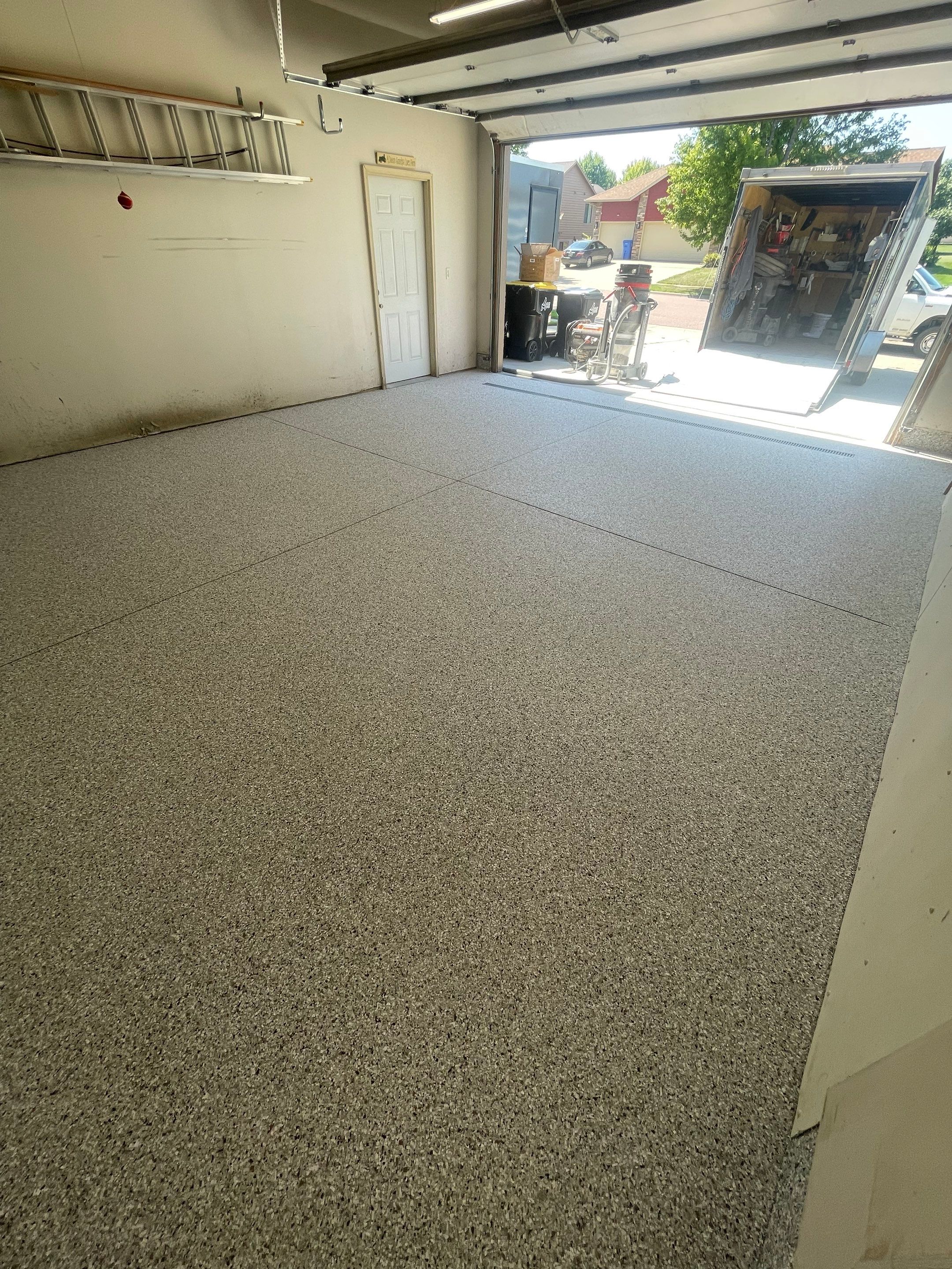 Multi-Stall Garage Floor Coating Installation in Sioux Falls by Select Painting, Coatings & Garage Cabinets