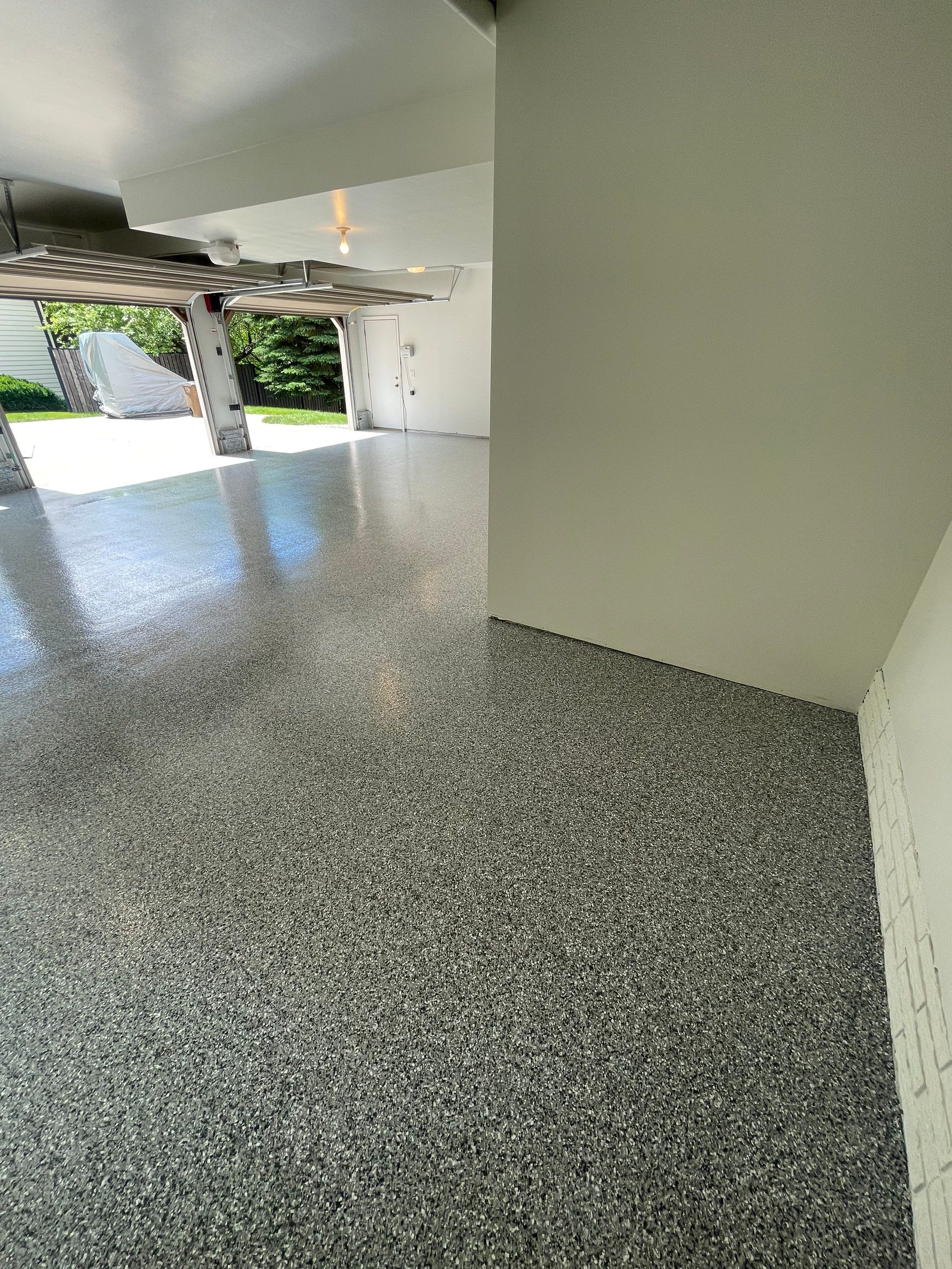 Gray Speckled Epoxy Garage Floor Coating in Sioux Falls by Select Painting, Coatings & Garage Cabinets