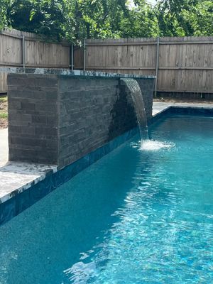 Geometric Pool with Stone Waterfall Wall