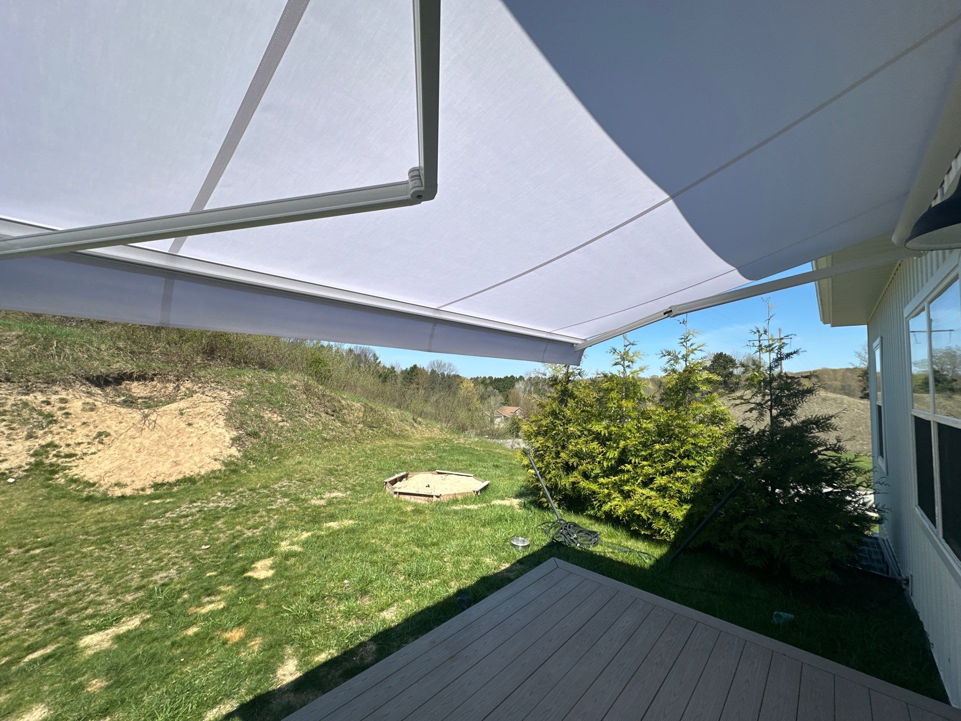 Sunesta Retractable Awning Installation for Traverse City Composite Deck by Rainbow Seamless Systems