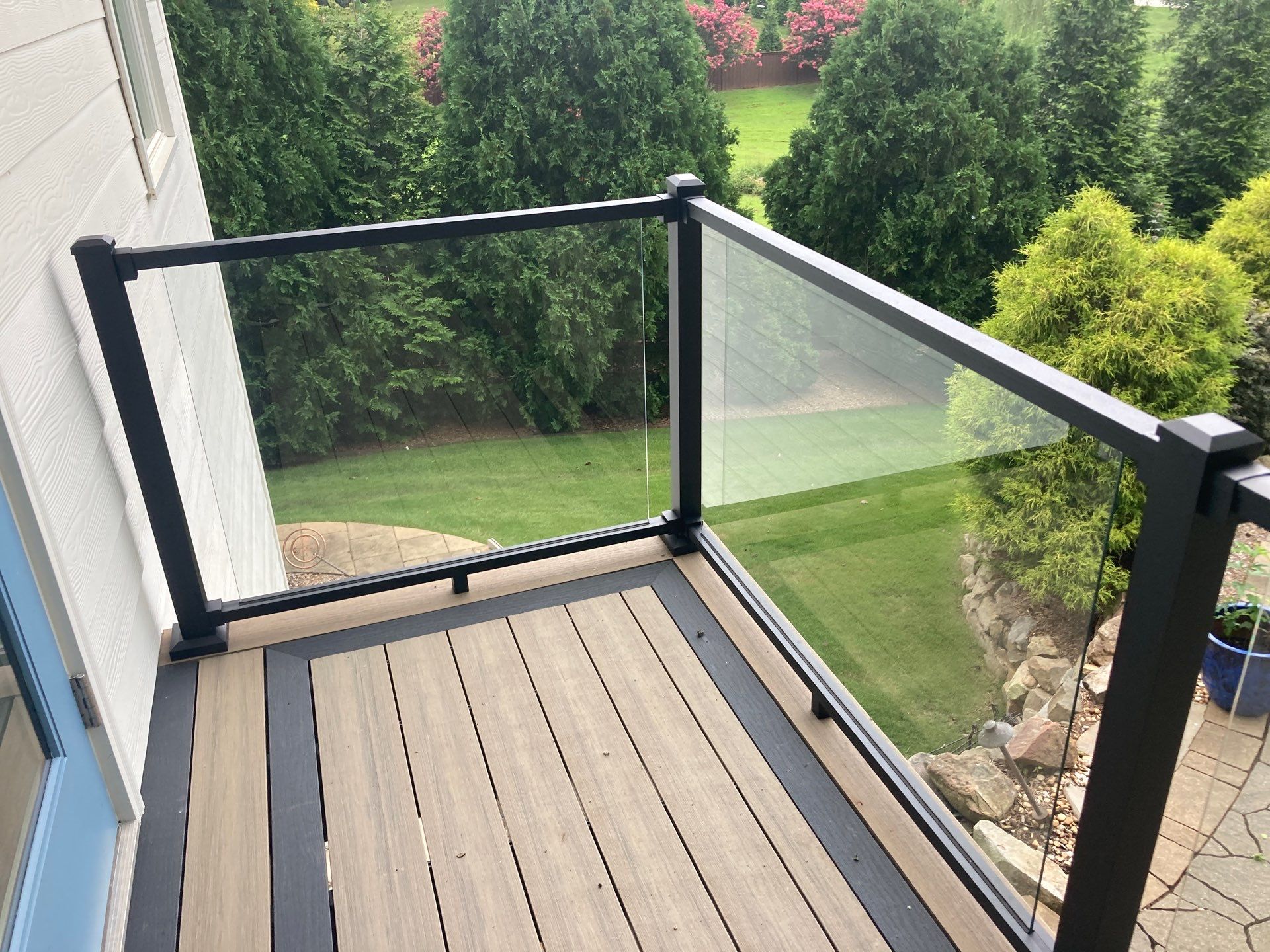 Deck Resurface with Glass Paneling and Deckorators Voyage Series Products by Nelson Exteriors 